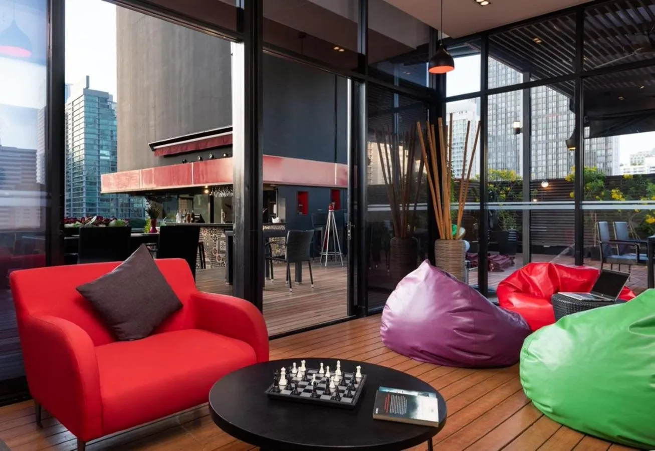 Communal lounge/ TV room in Maitria Mode Sukhumvit 15 Bangkok - A Chatrium Collection