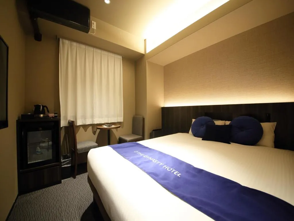 Bed in Dynasty Hotel & Resort Osaka