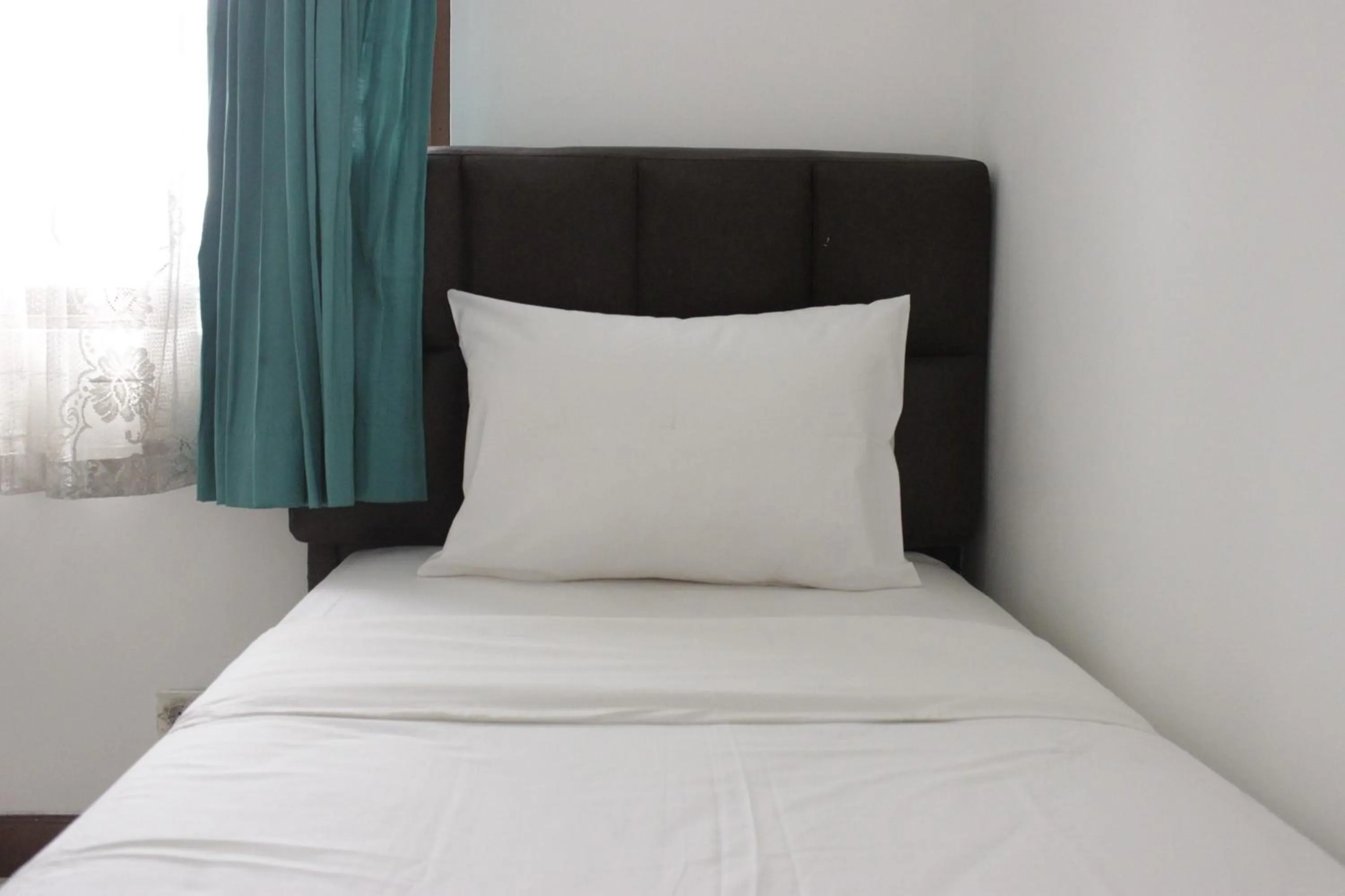 Bed in Homey 2BR Majesty Apartment near Maranatha University By Travelio