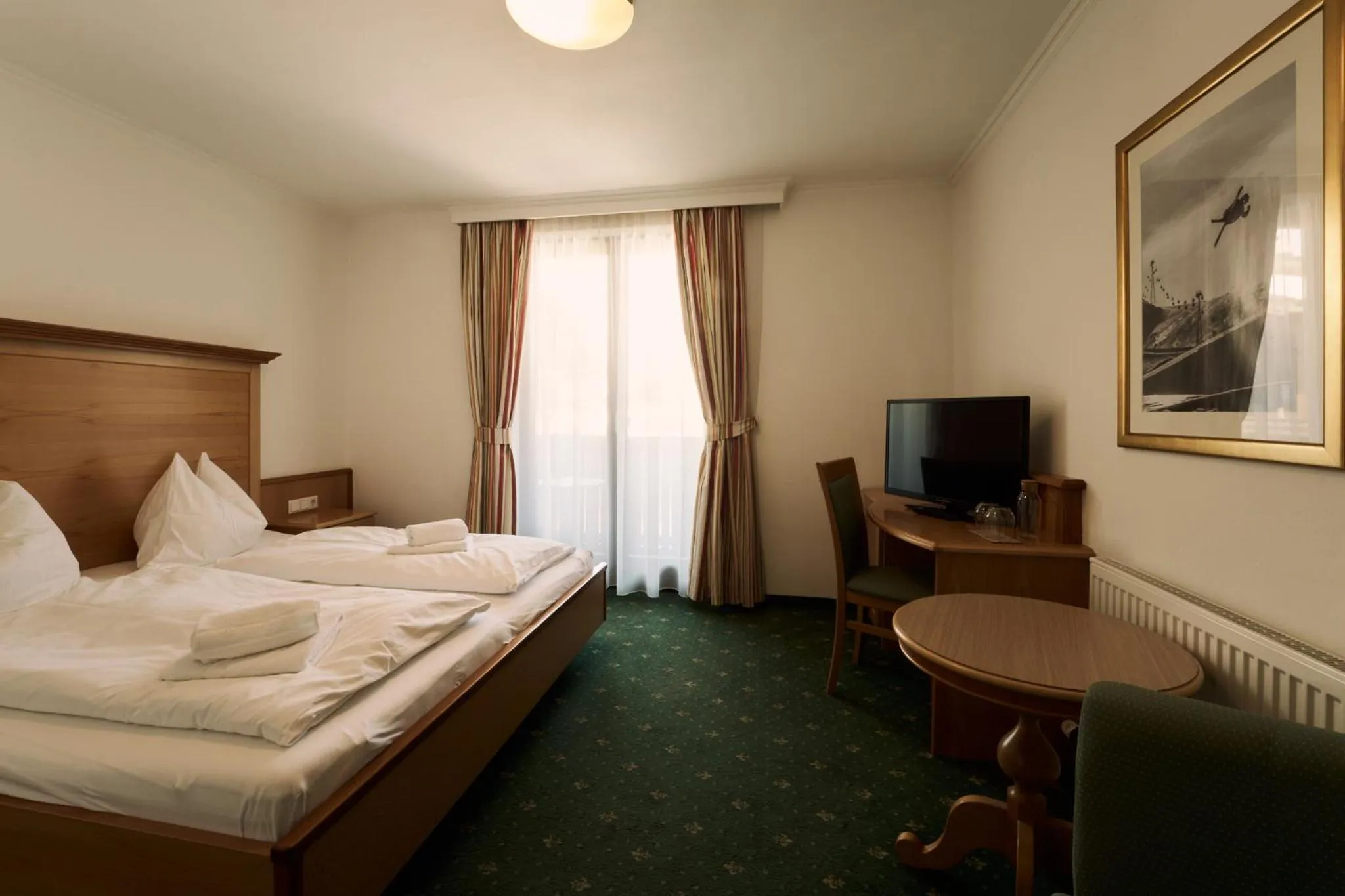 Photo of the whole room, Bed in Hotel Martini Kaprun inkluding breakfast & free parking