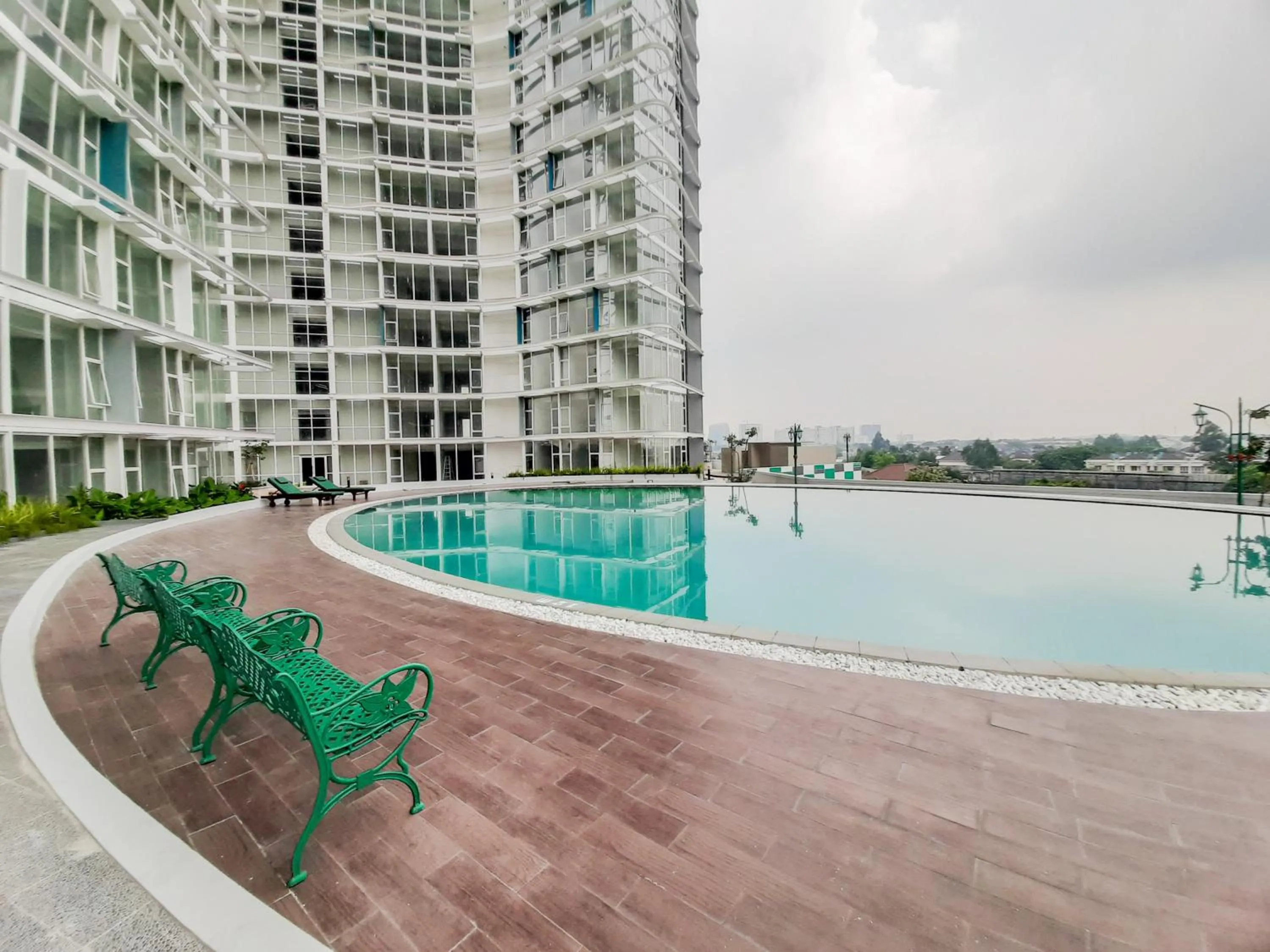 Swimming pool in Fully Furnished Studio with Comfort Design Majestic Point Serpong Apartment By Travelio