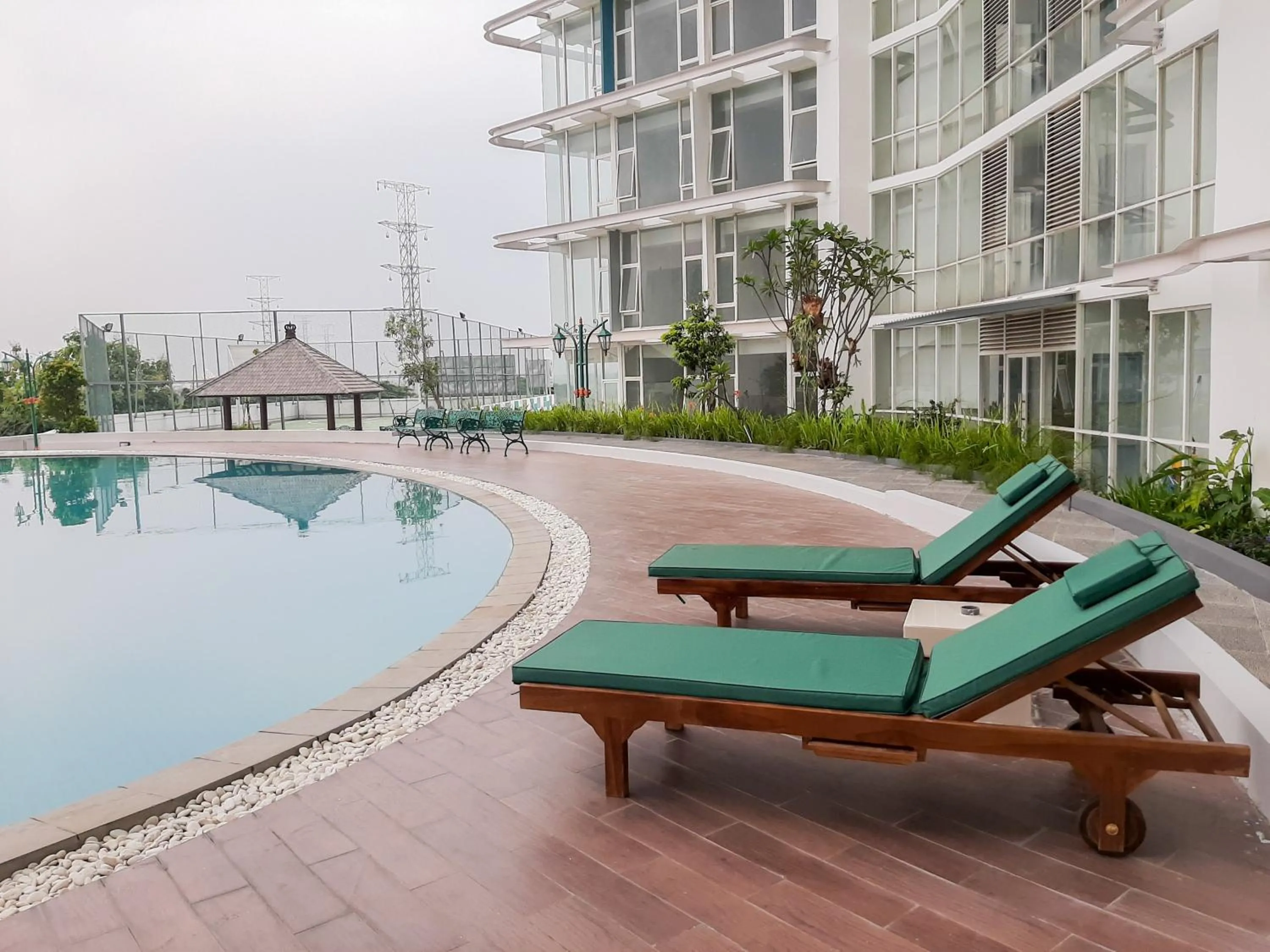 Swimming pool in Fully Furnished Studio with Comfort Design Majestic Point Serpong Apartment By Travelio