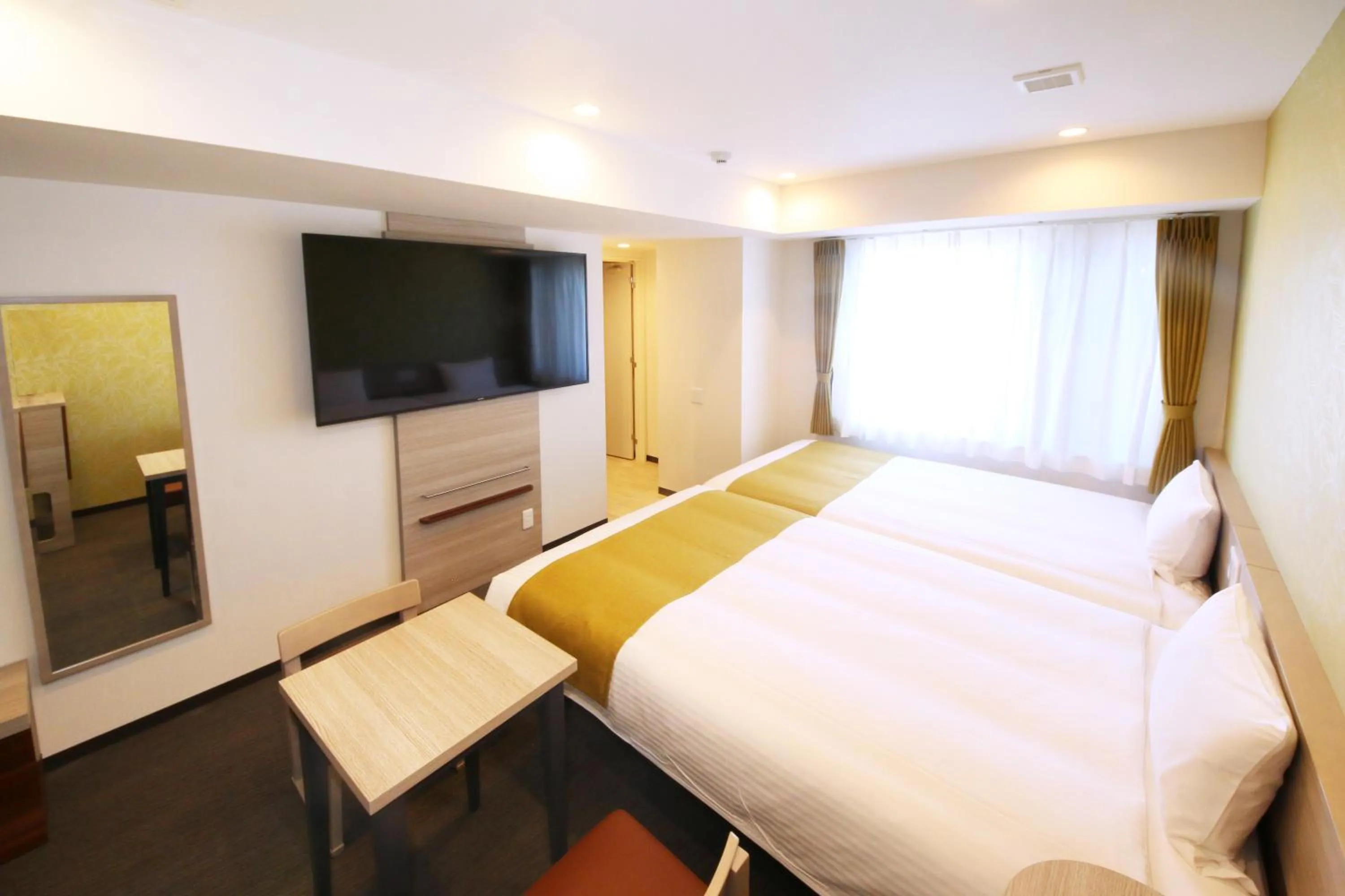 Bed in Kuretake Inn Premium Numazu Kitaguchi Ekimae