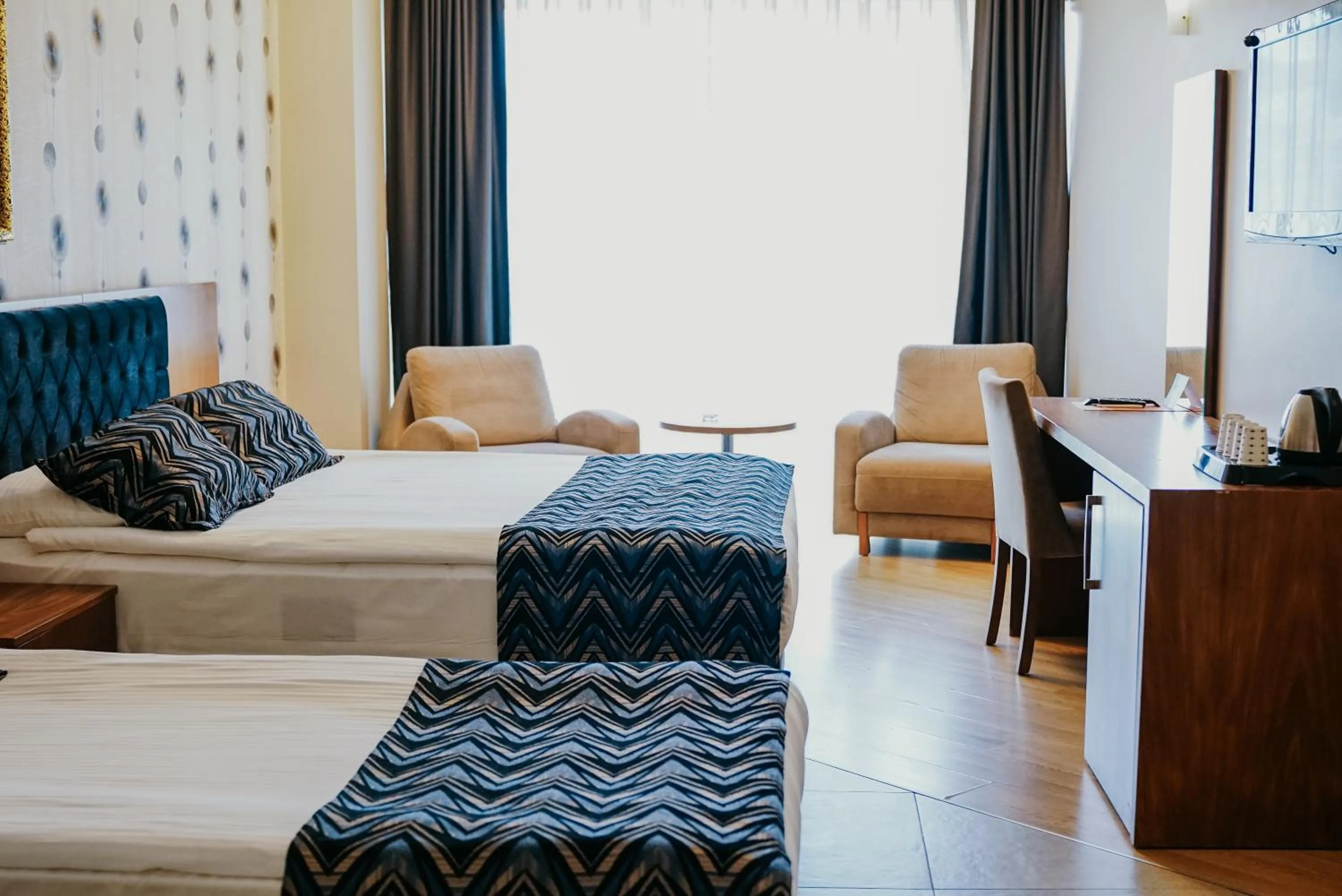 Communal lounge/ TV room, Bed in Grand Karot Hotel