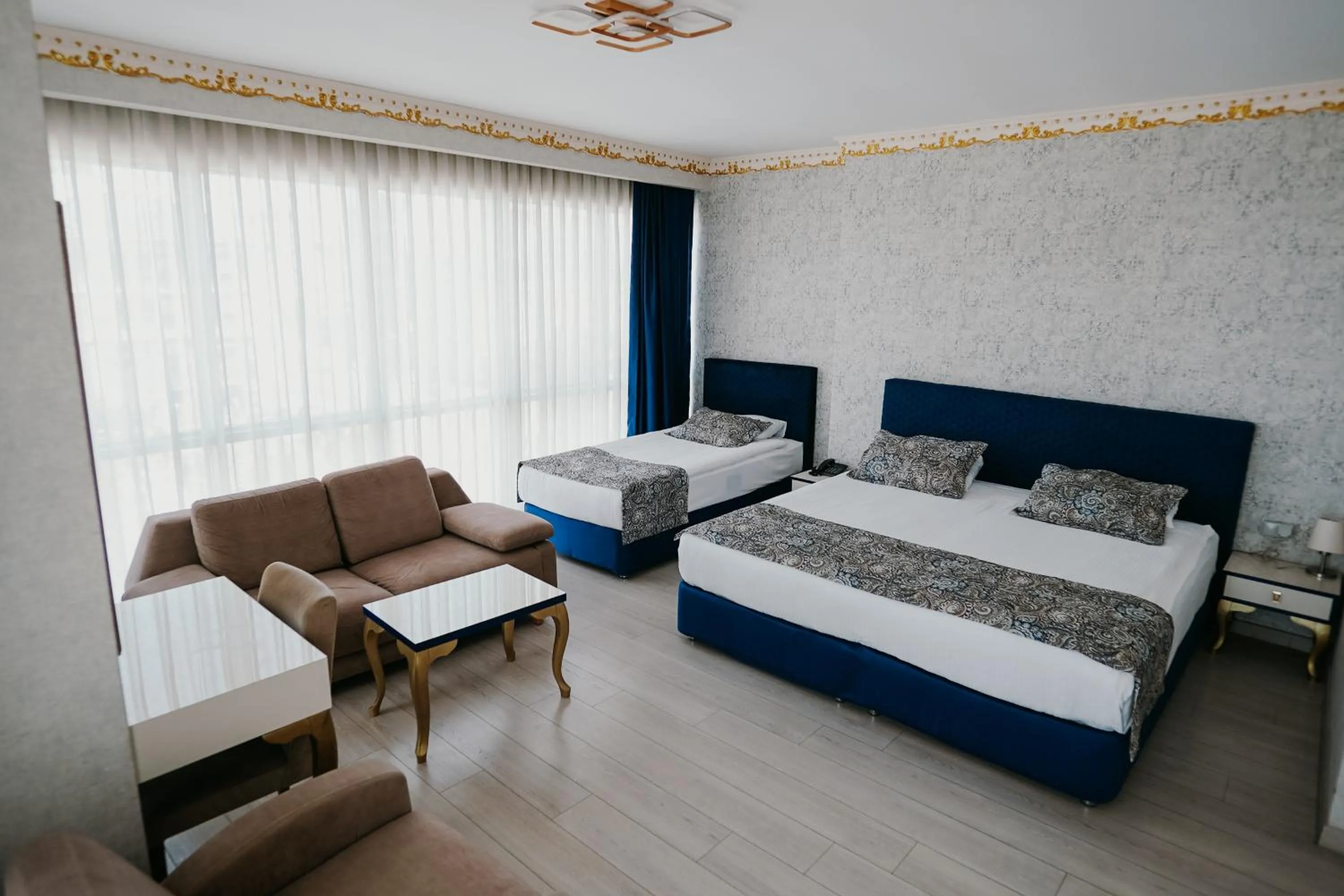 Communal lounge/ TV room, Bed in Grand Karot Hotel