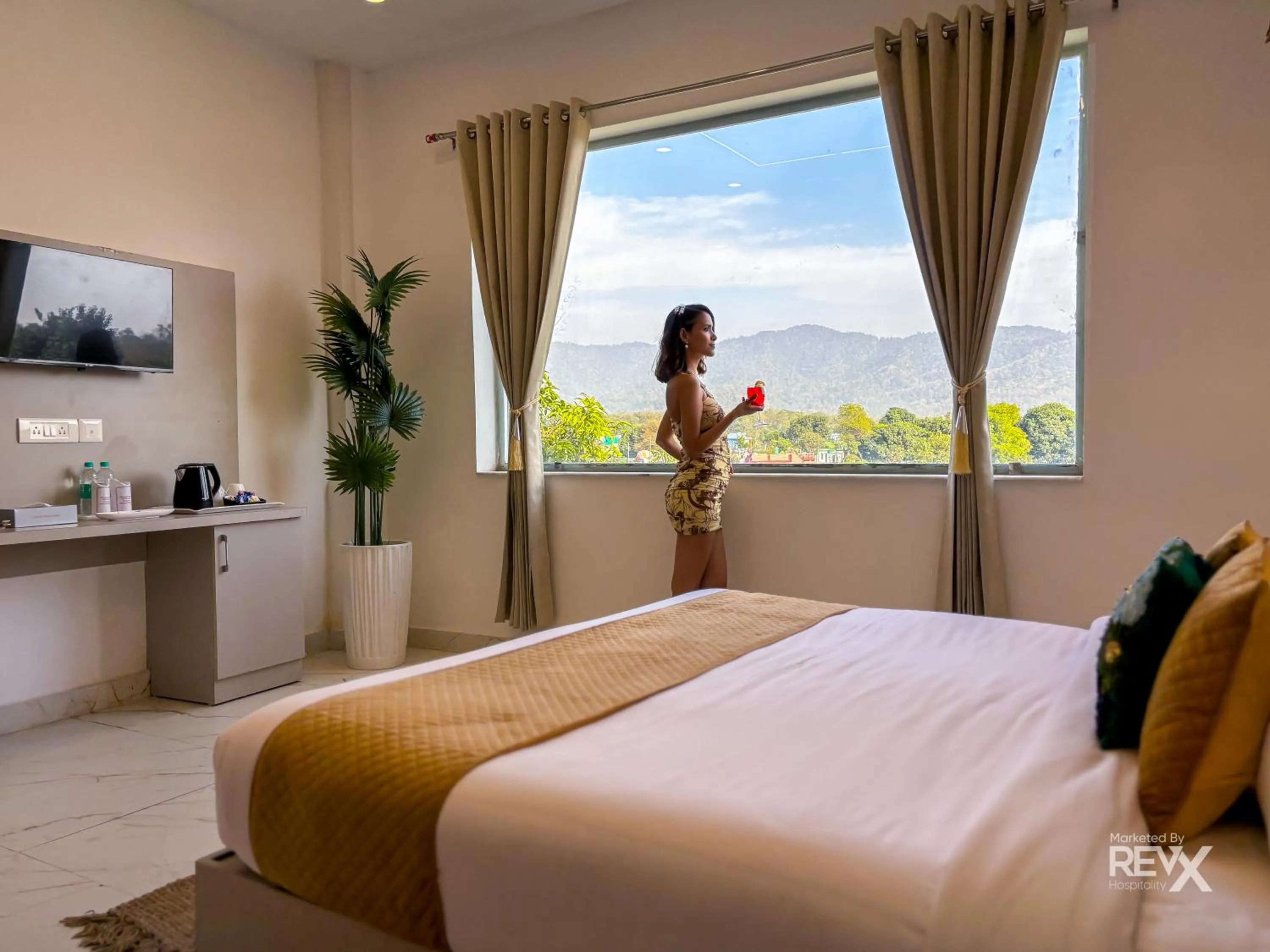 Bed in The Neeraj River Forest Resort Ayurvedic Wellness Center