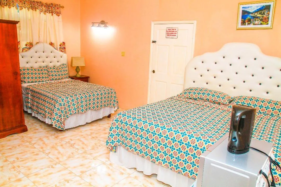 Bed in Dela de-Rose Guest House Negril Jamaica