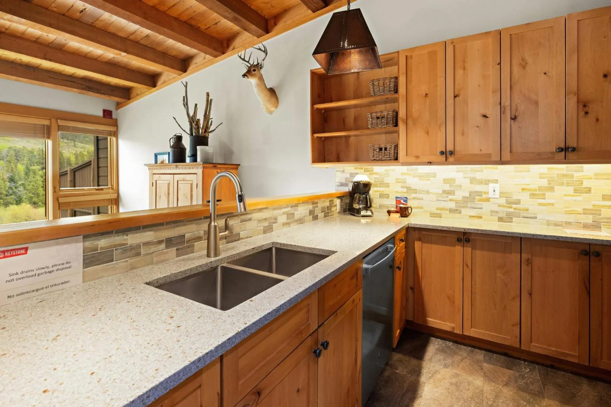 Communal kitchen in Evergreen Condominiums by Vail Resorts