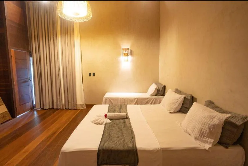 Bed in Pousada Rota dos Ventos