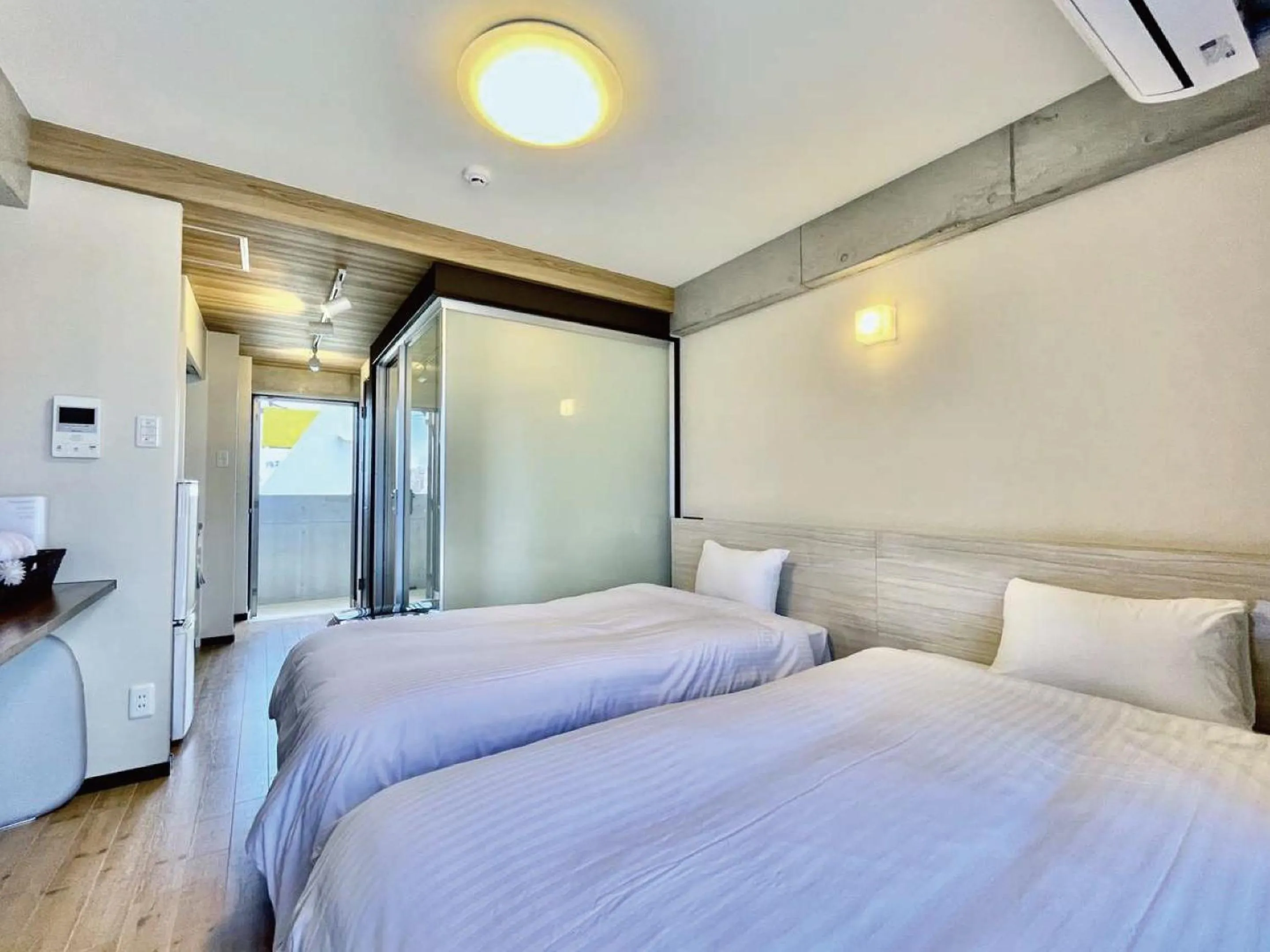 Bed in Infinity Hotel NahaKumoji -SEVEN Hotels and Resorts-