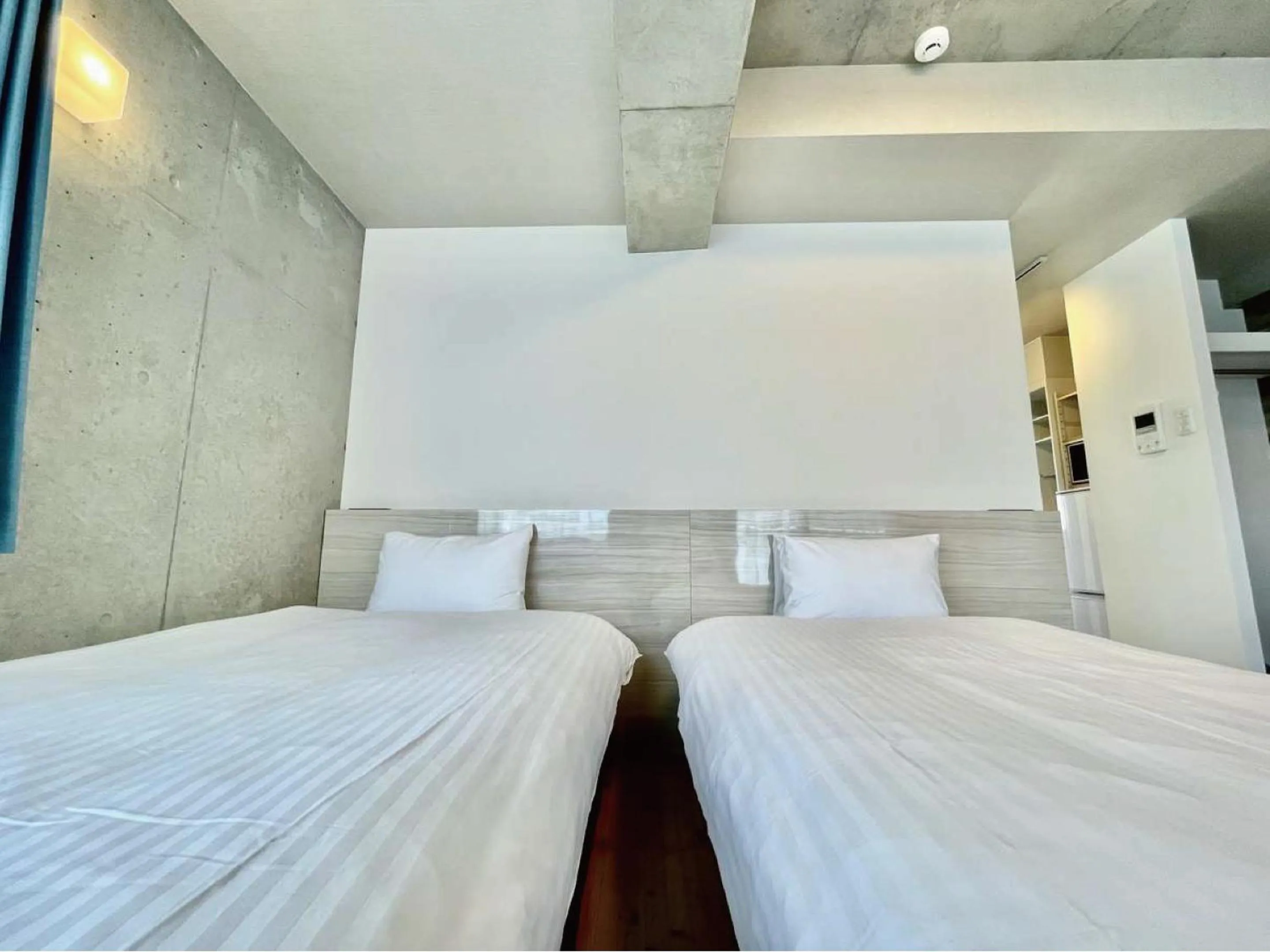 Bed in Infinity Hotel NahaKumoji -SEVEN Hotels and Resorts-