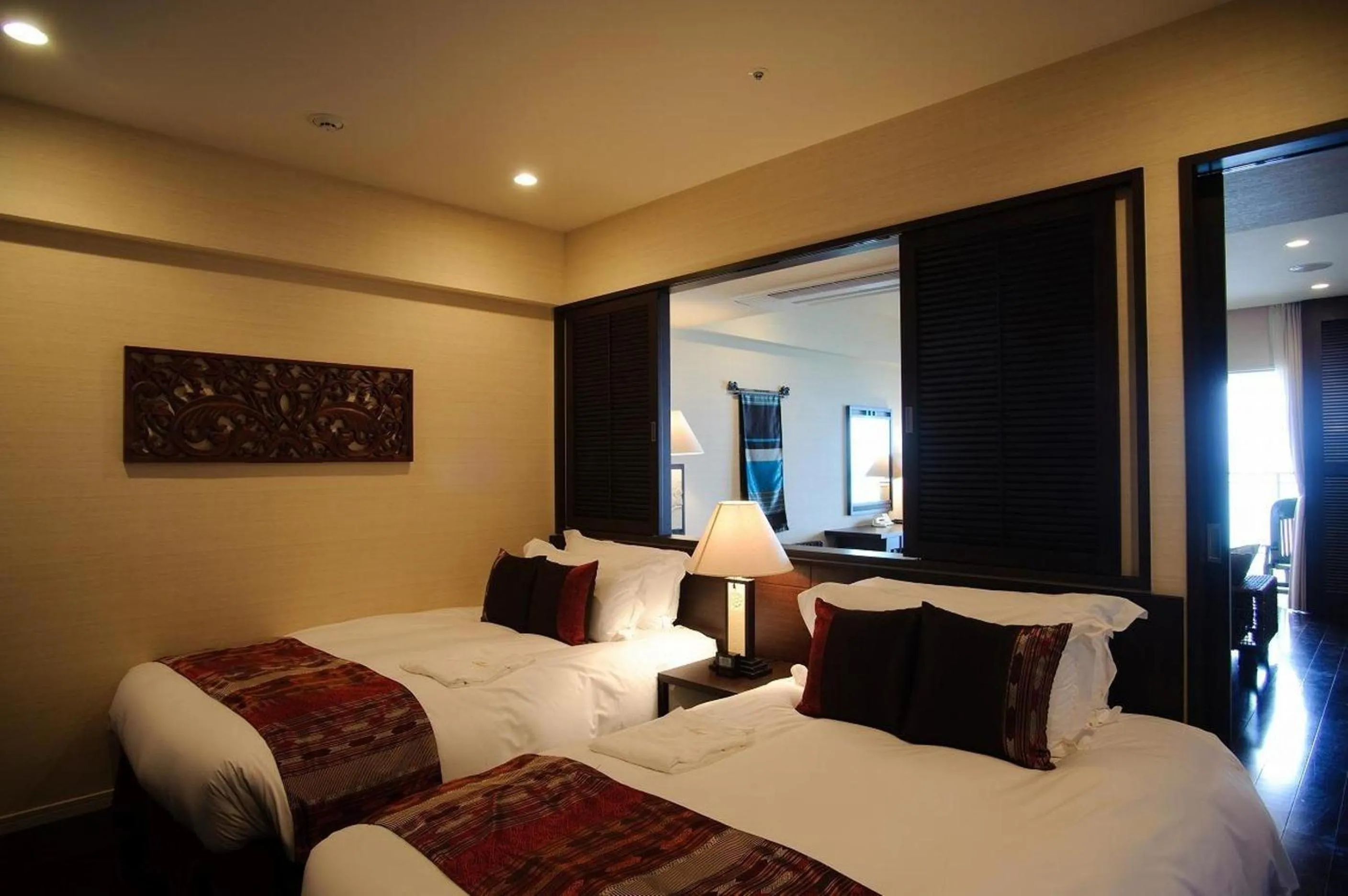 Bed in Kafuu Resort Fuchaku Condo Hotel