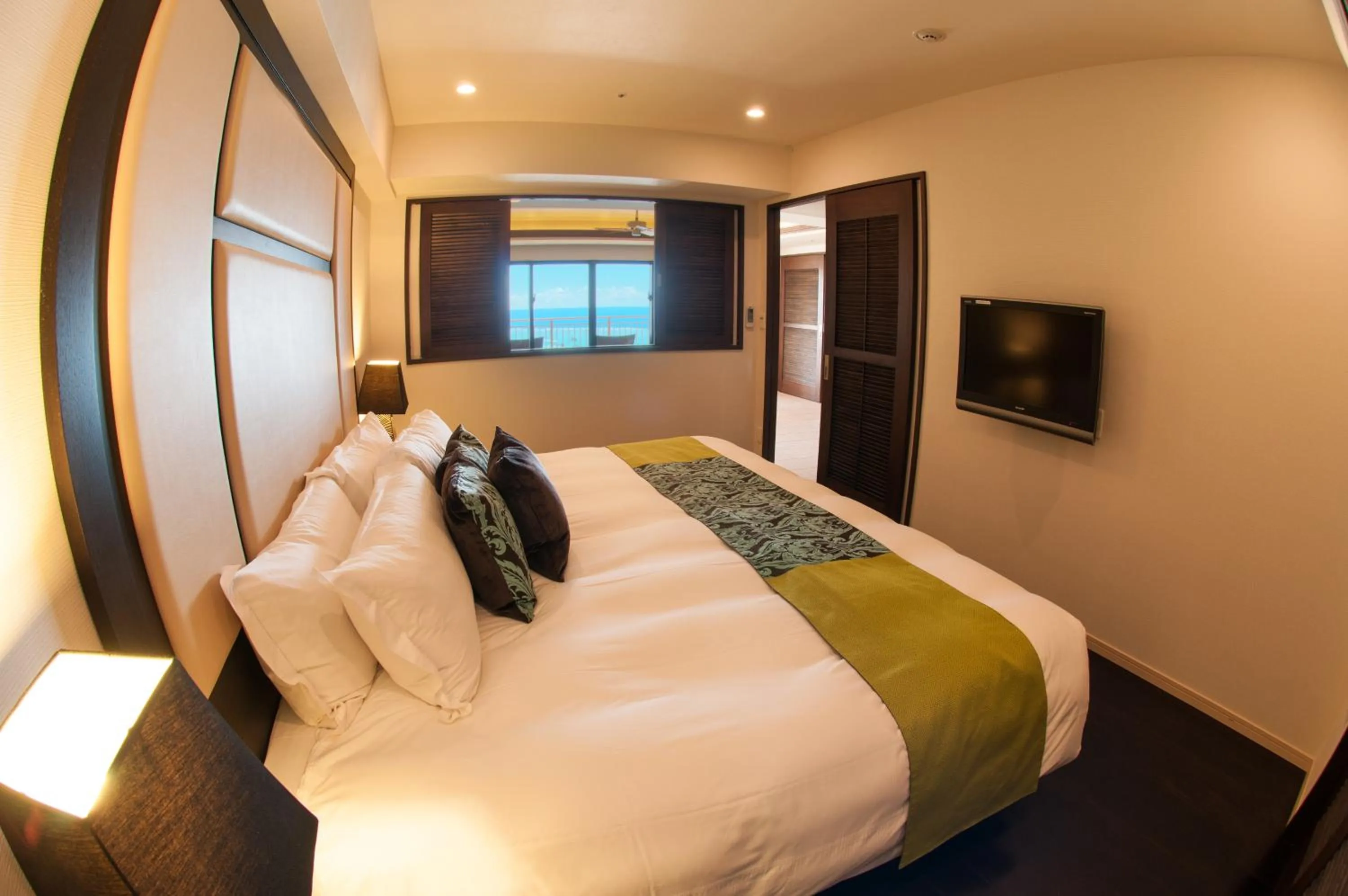 Bed in Kafuu Resort Fuchaku Condo Hotel