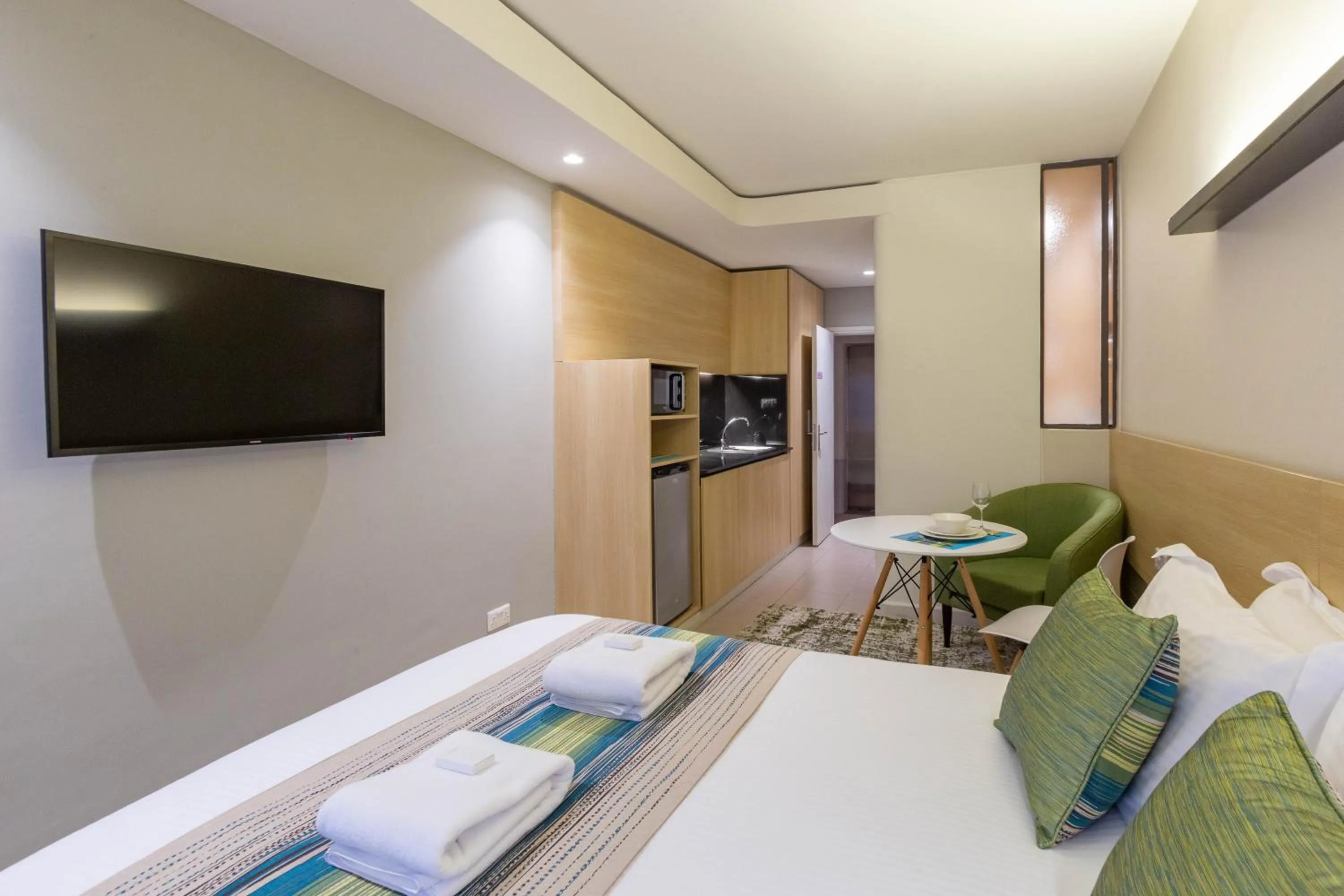 Photo of the whole room, Bed in Kozi Suites Nairobi Airport