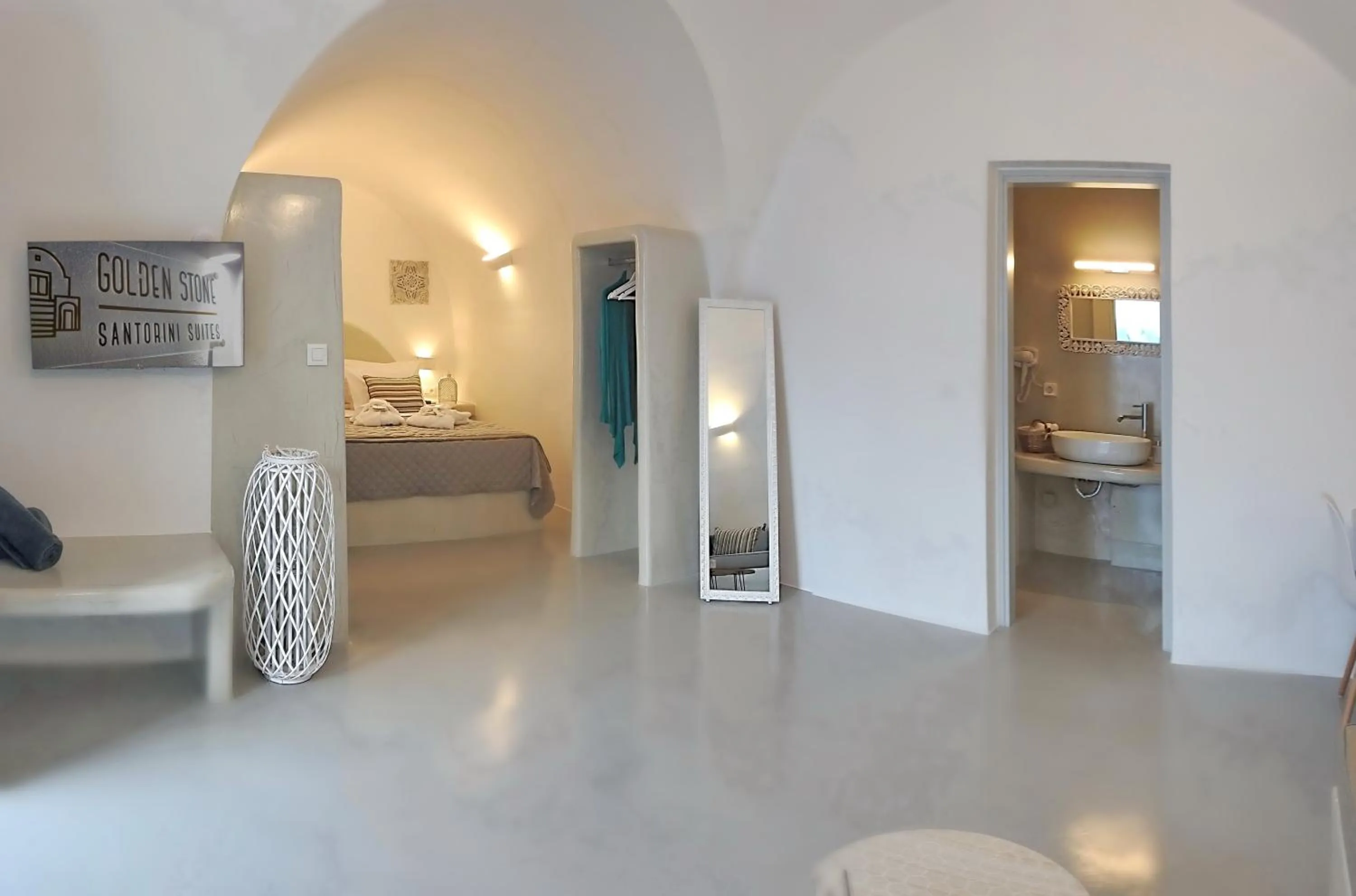 Bed in Golden Stone Santorini Suites