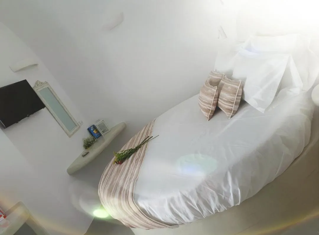 Bed in Golden Stone Santorini Suites