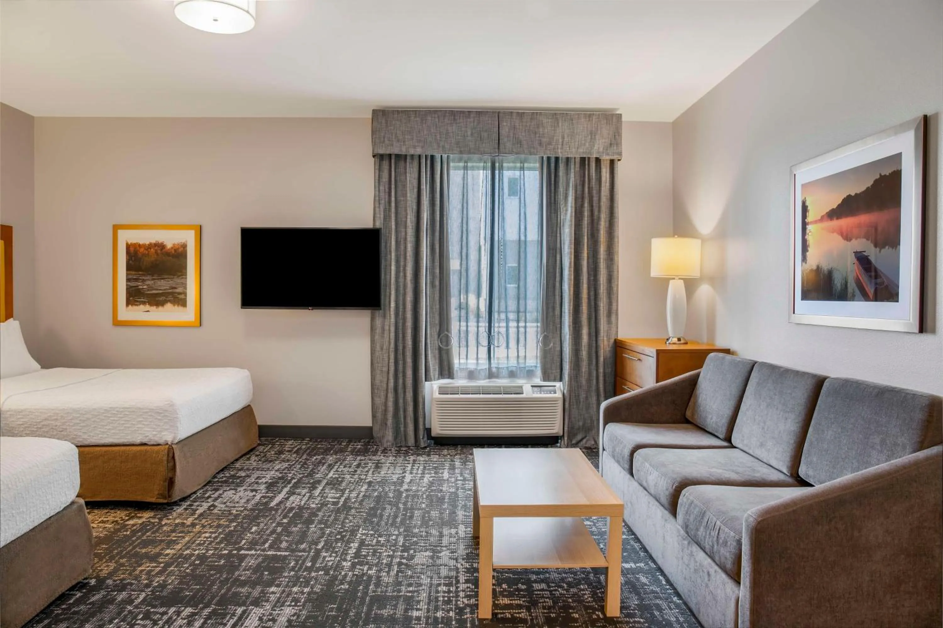 Living room, Bed in Homewood Suites by Hilton Winnipeg Airport - Polo Park