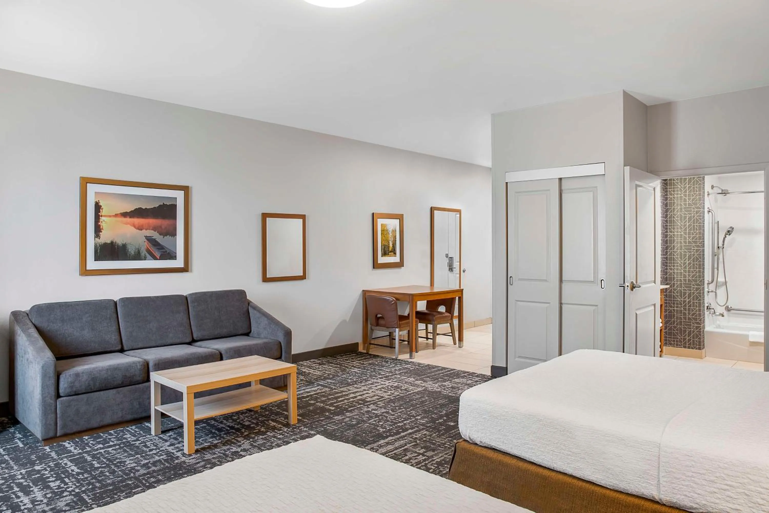Living room, Bed in Homewood Suites by Hilton Winnipeg Airport - Polo Park