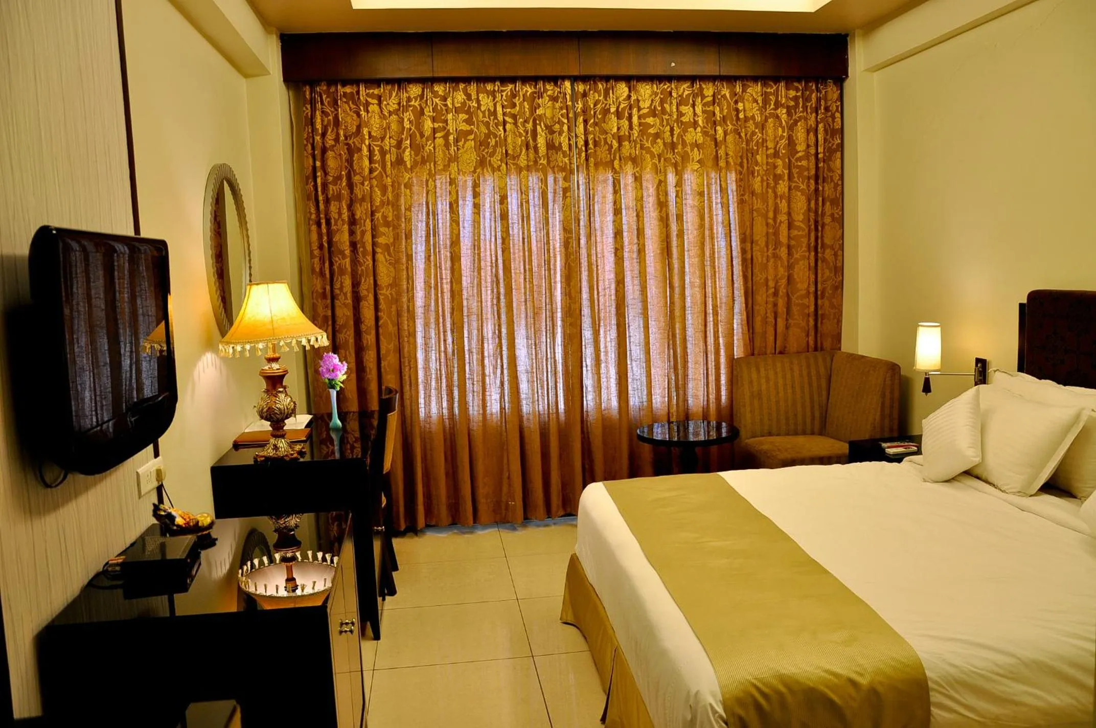 Photo of the whole room, Bed in Pramod Convention & Club Resort