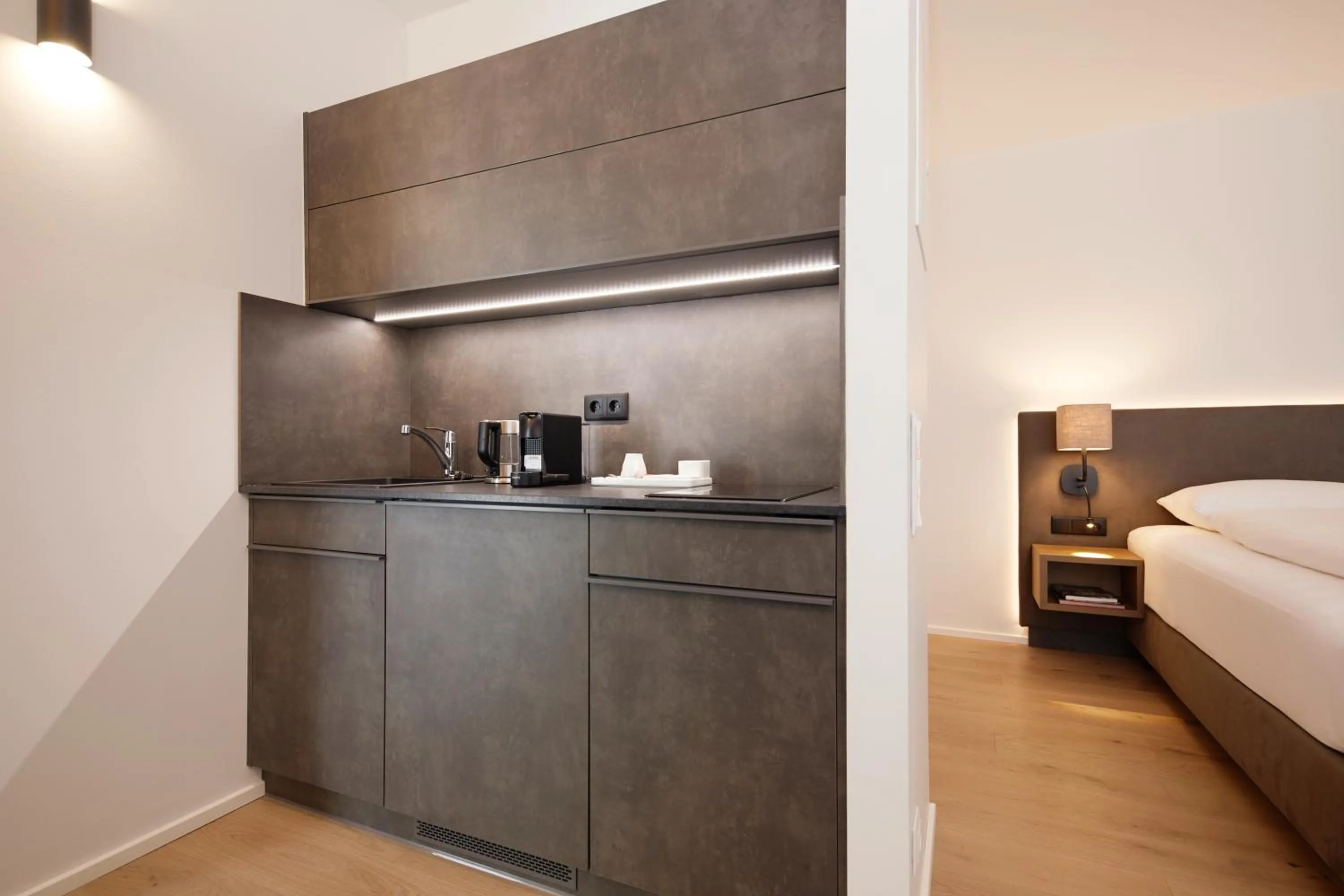 Kitchen or kitchenette, Bed in Hotel Gösser Bräu