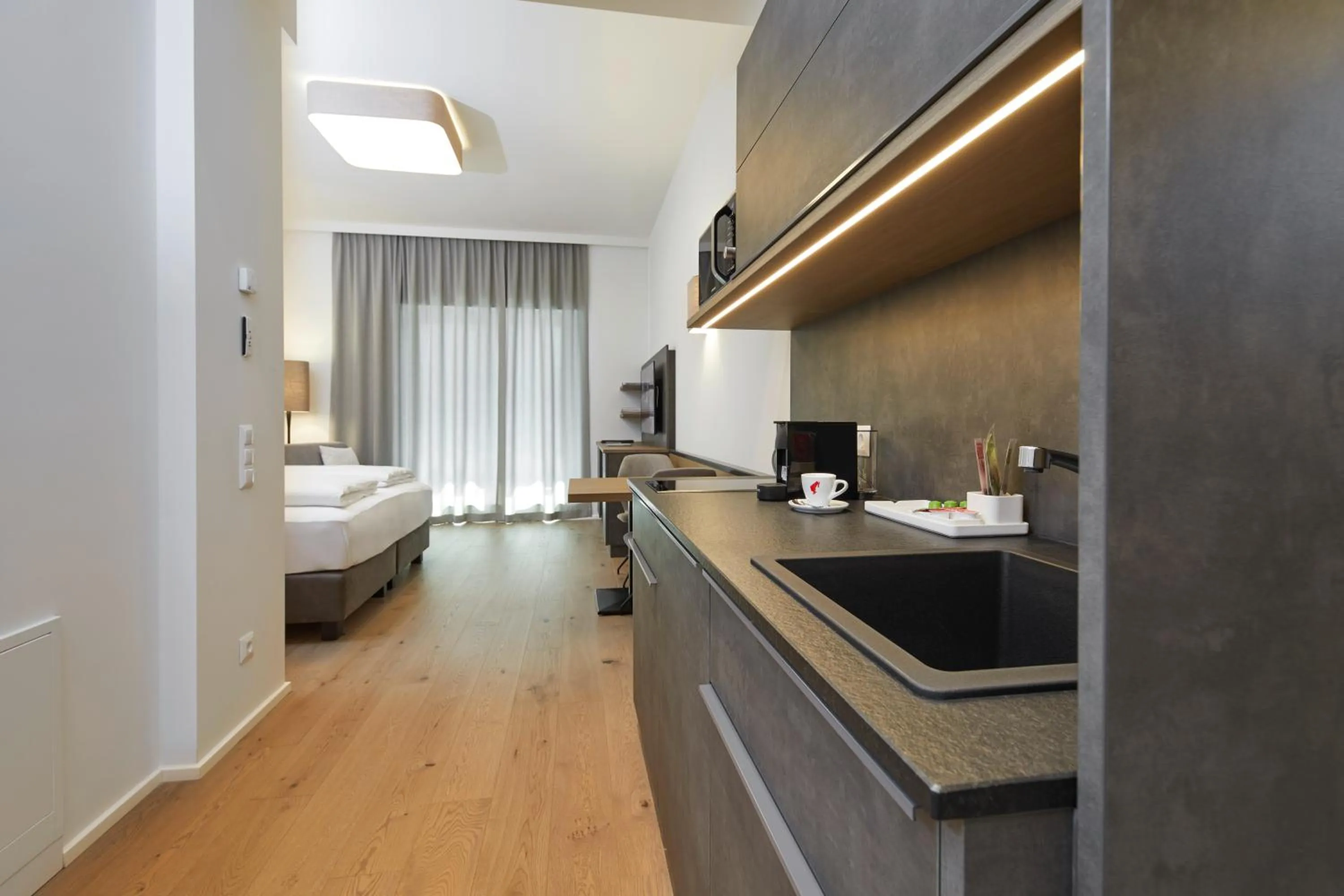 Kitchen or kitchenette, Bed in Hotel Gösser Bräu