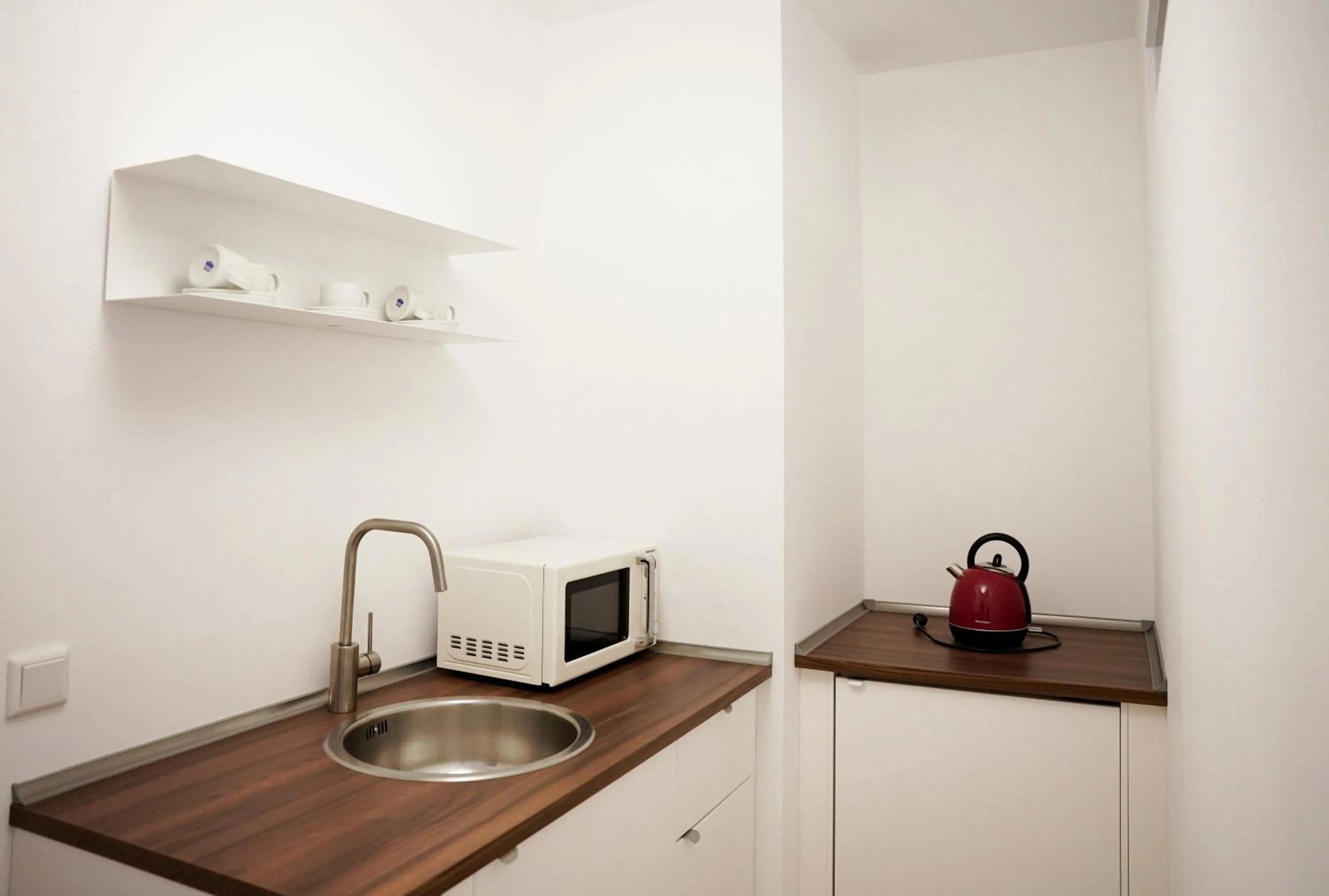 Kitchen or kitchenette in urraum Hotel
