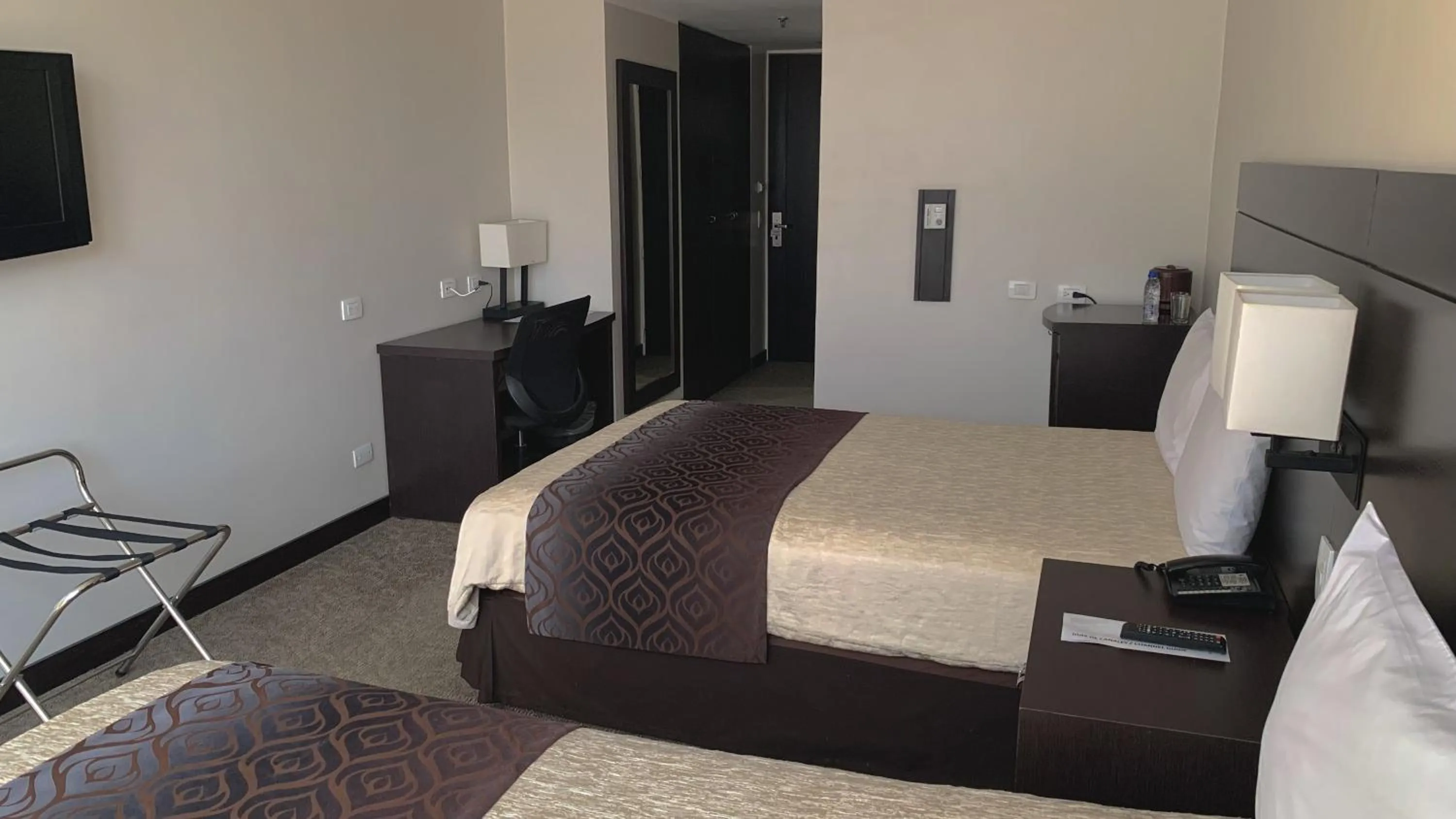 Bed in HOTEL CHACAO SUITES