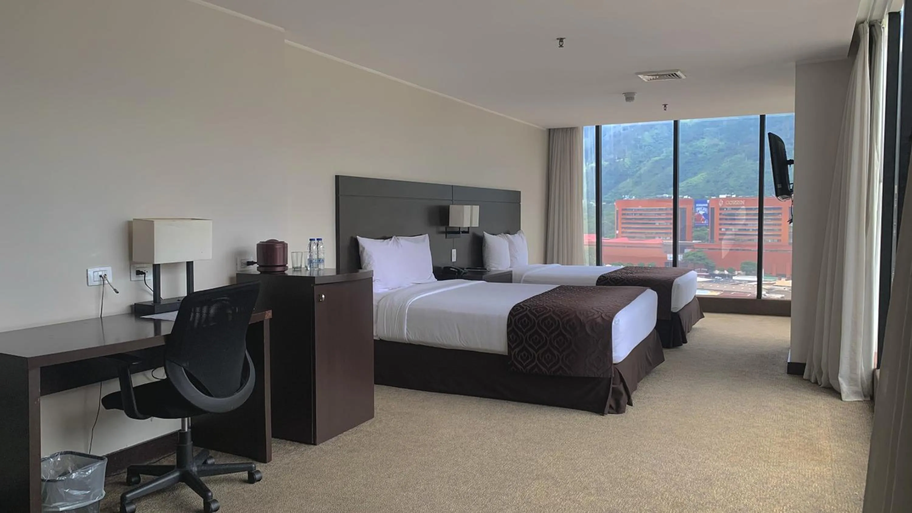 Bed in HOTEL CHACAO SUITES