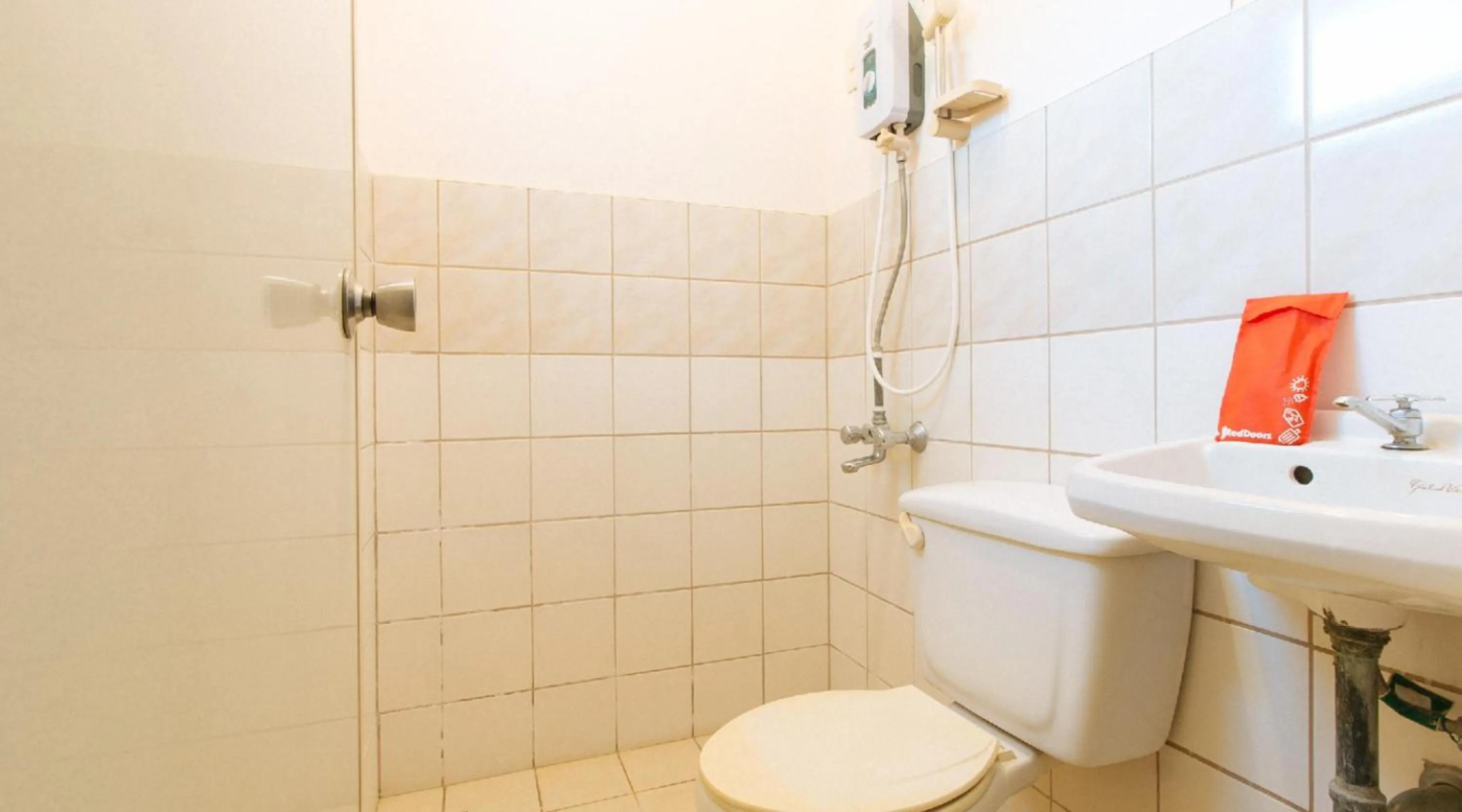 Toilet in RedDoorz Hostel at Megans Paradisio Beach Resort