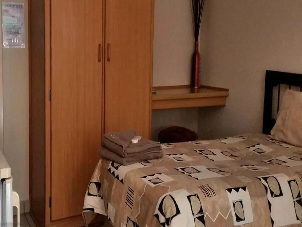 Bed in Country Blue Luxury Guest House