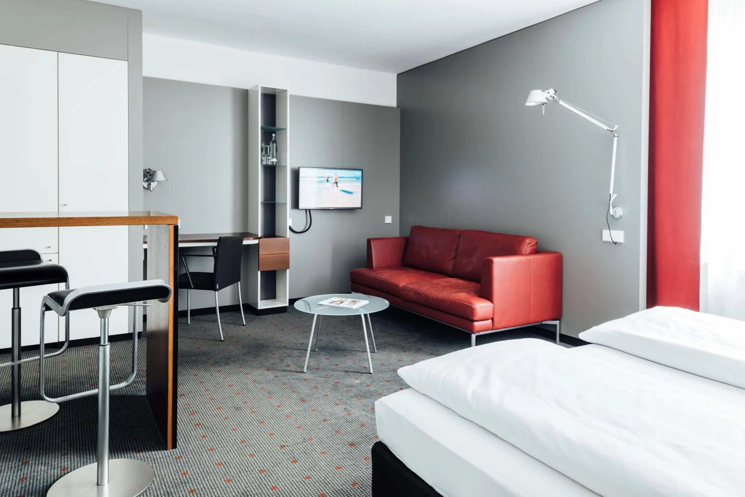 Seating area, Bed in Vienna House Easy by Wyndham Stuttgart