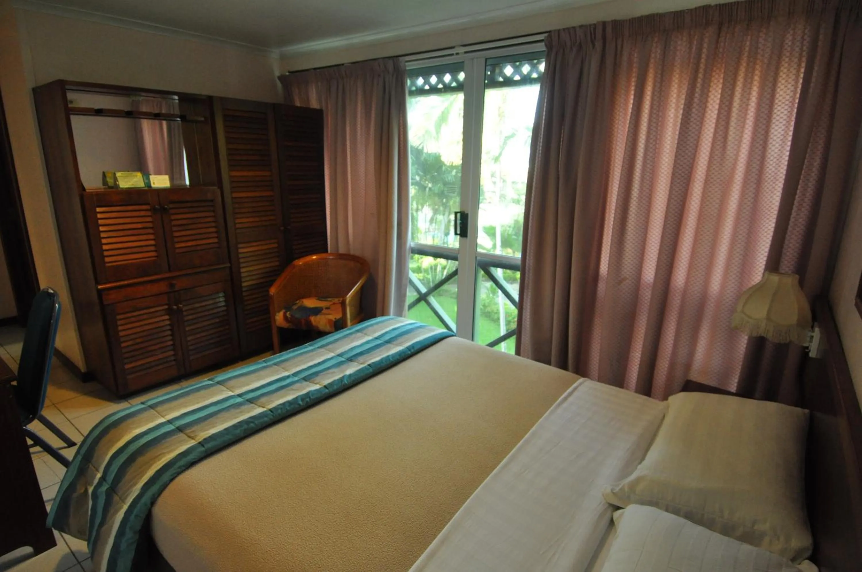 Seating area, Bed in Madang Resort