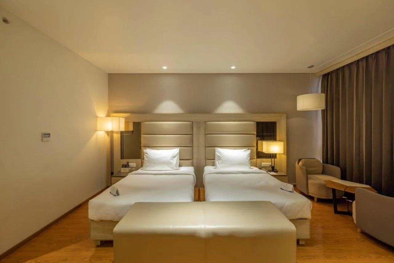 Bedroom in Sarovar Portico Morbi