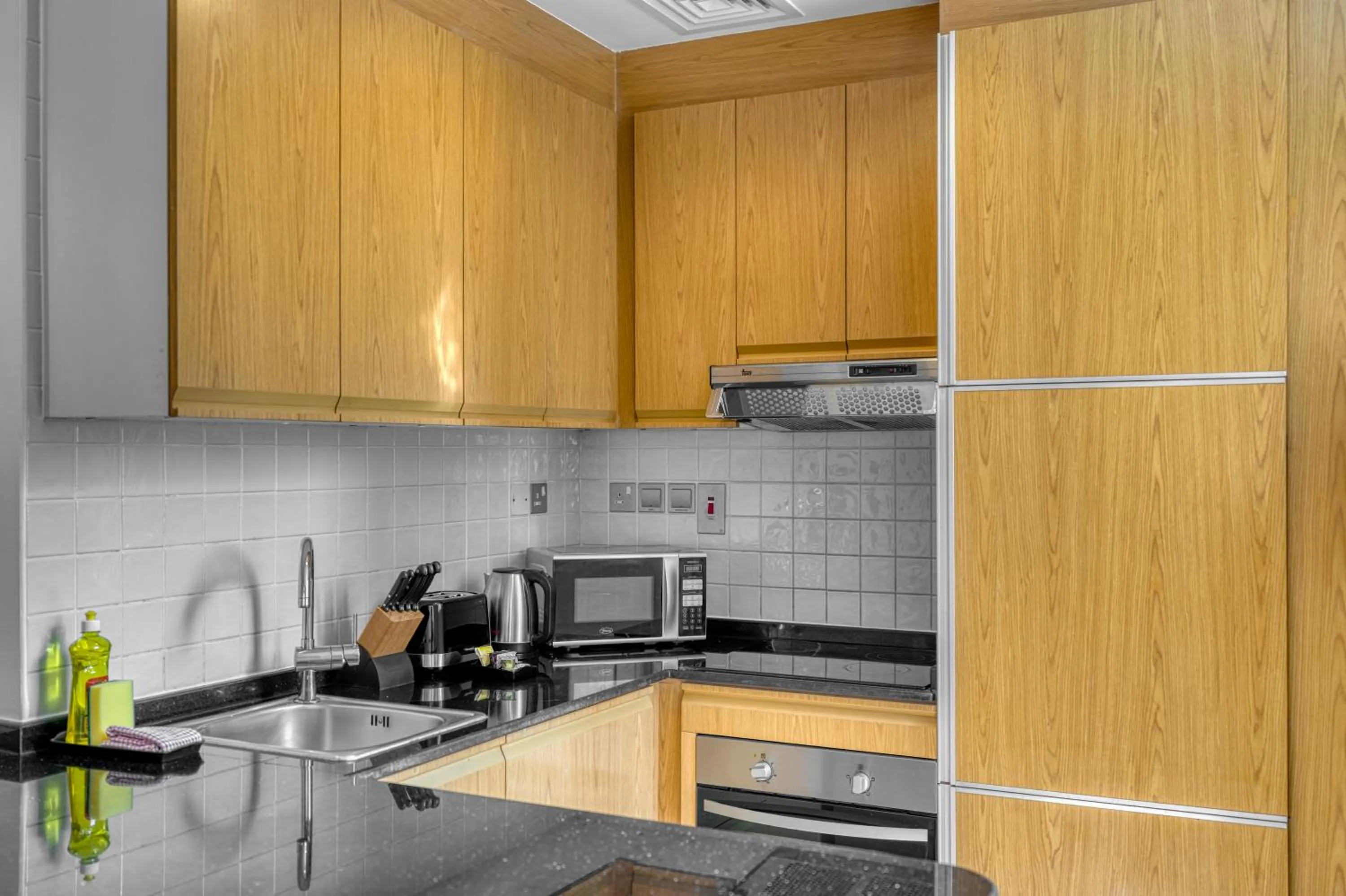 Kitchen or kitchenette in Grand Heights Dubai Hotel Apartments
