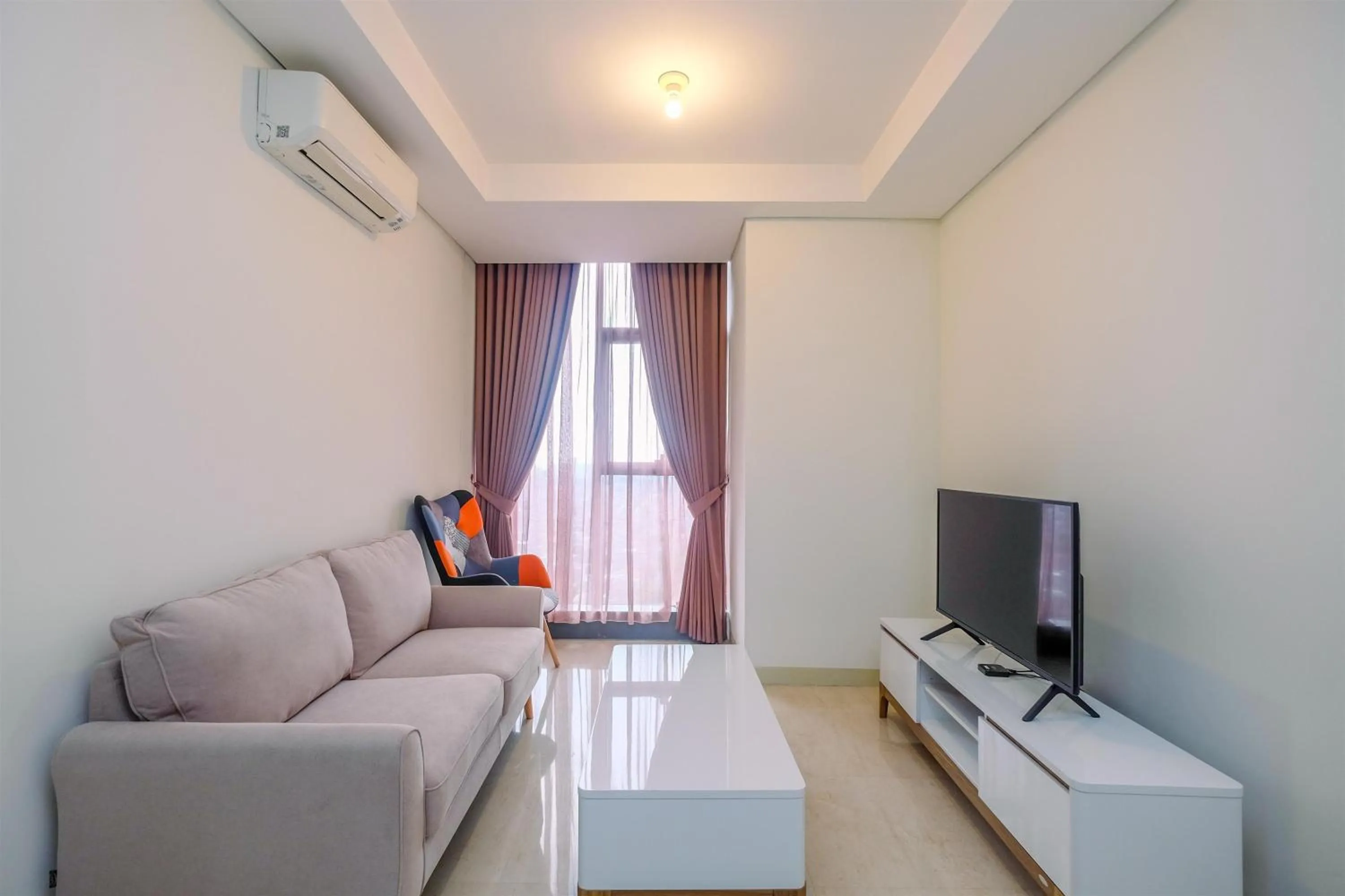 Living room in Brand New 2BR L'Avenue Apartment By Travelio