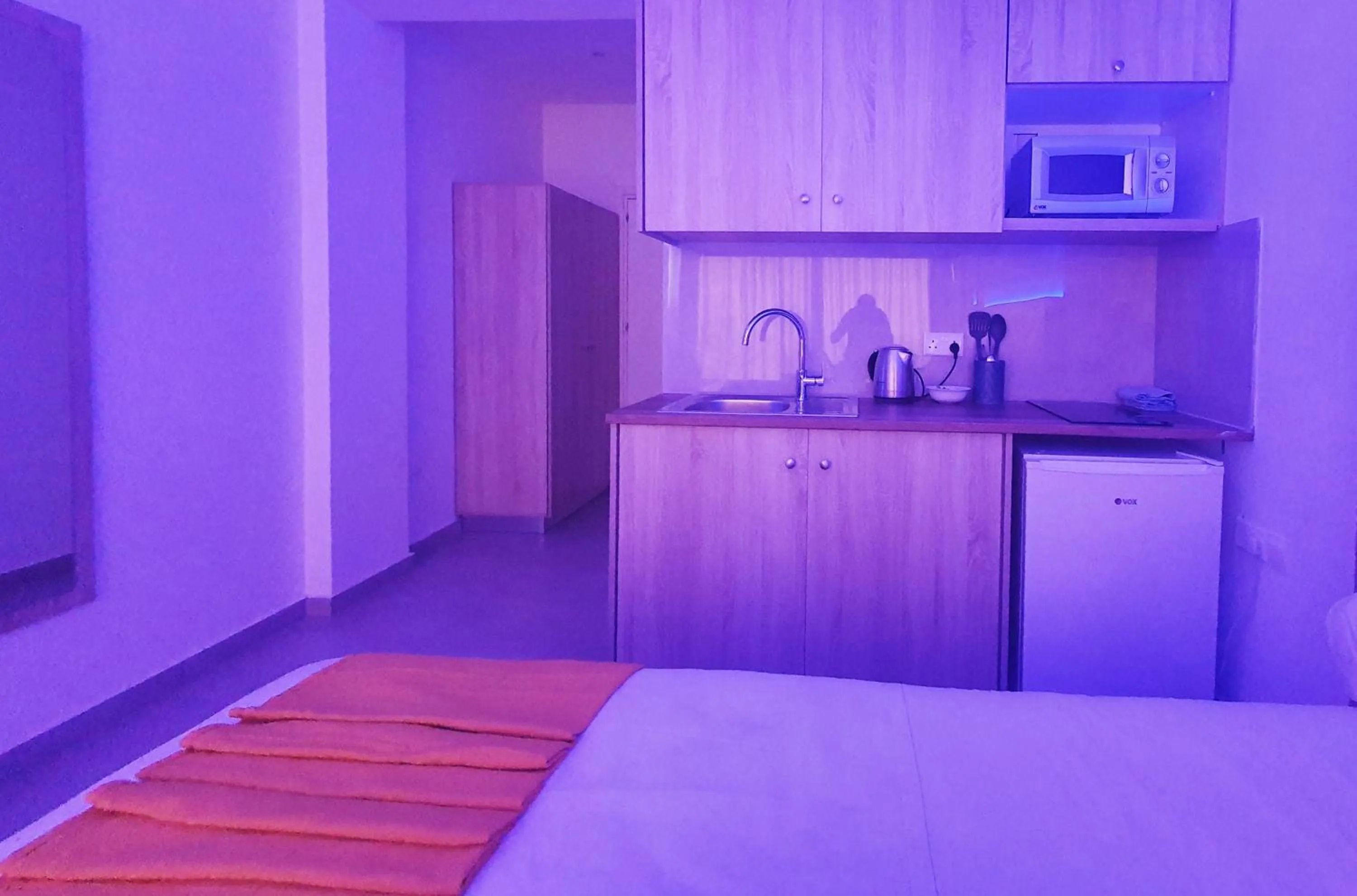 Kitchen or kitchenette, Bed in Sun Plaza Suites - Adults Only