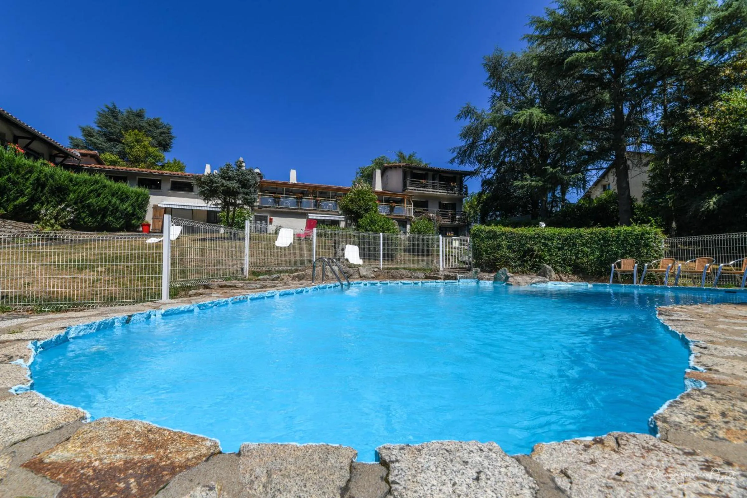 Swimming pool in Logis Hôtel La Chaumière