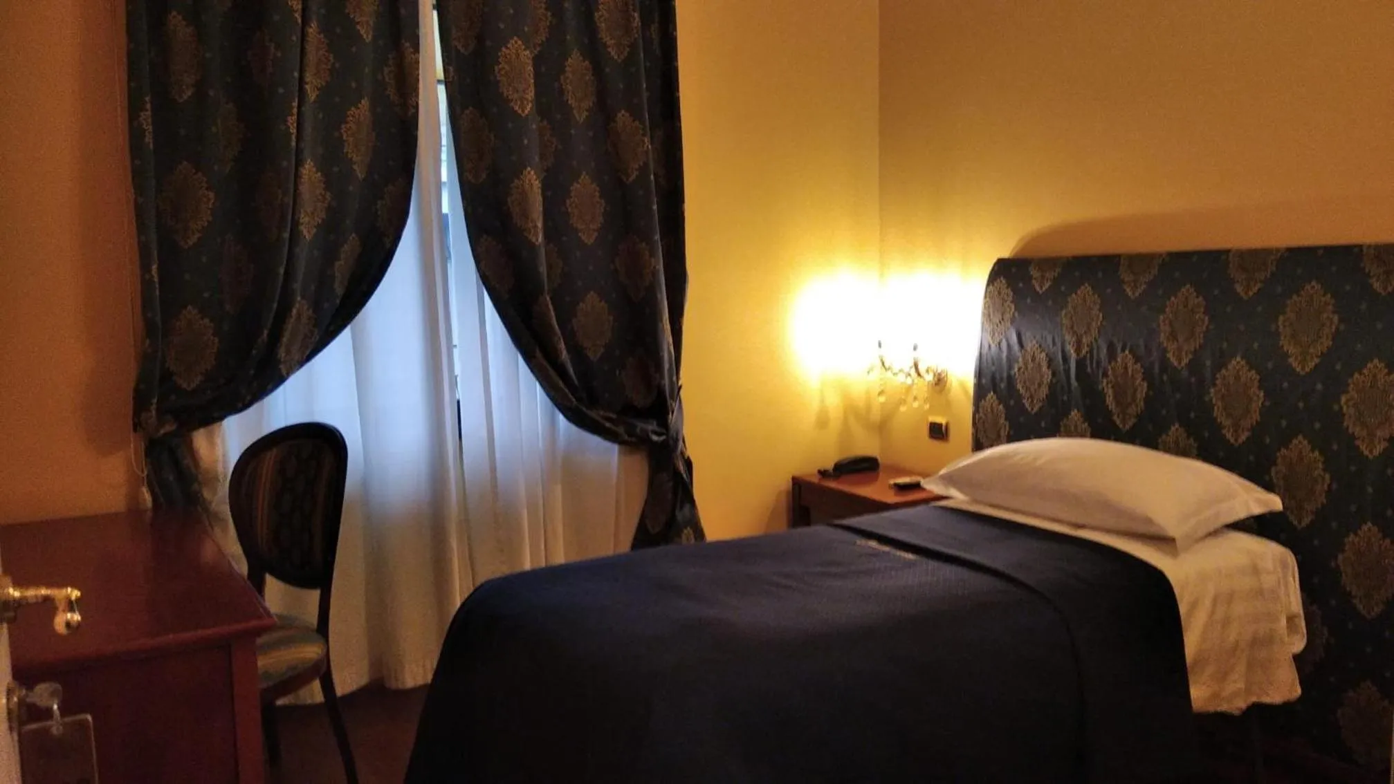 Bed in CANELLA HOTEL