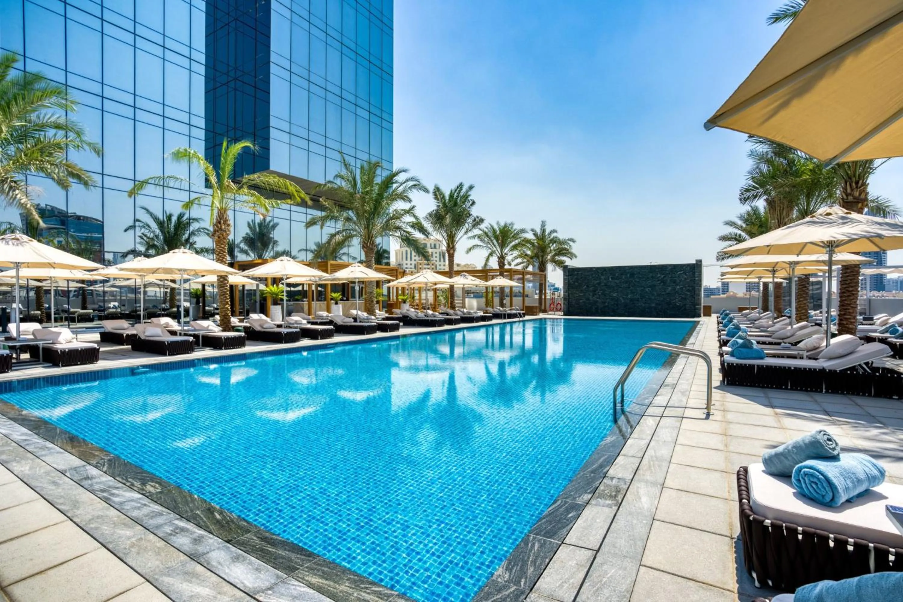 Swimming pool in The First Collection Dubai Jumeirah Village Circle, a Tribute Portfolio Hotel
