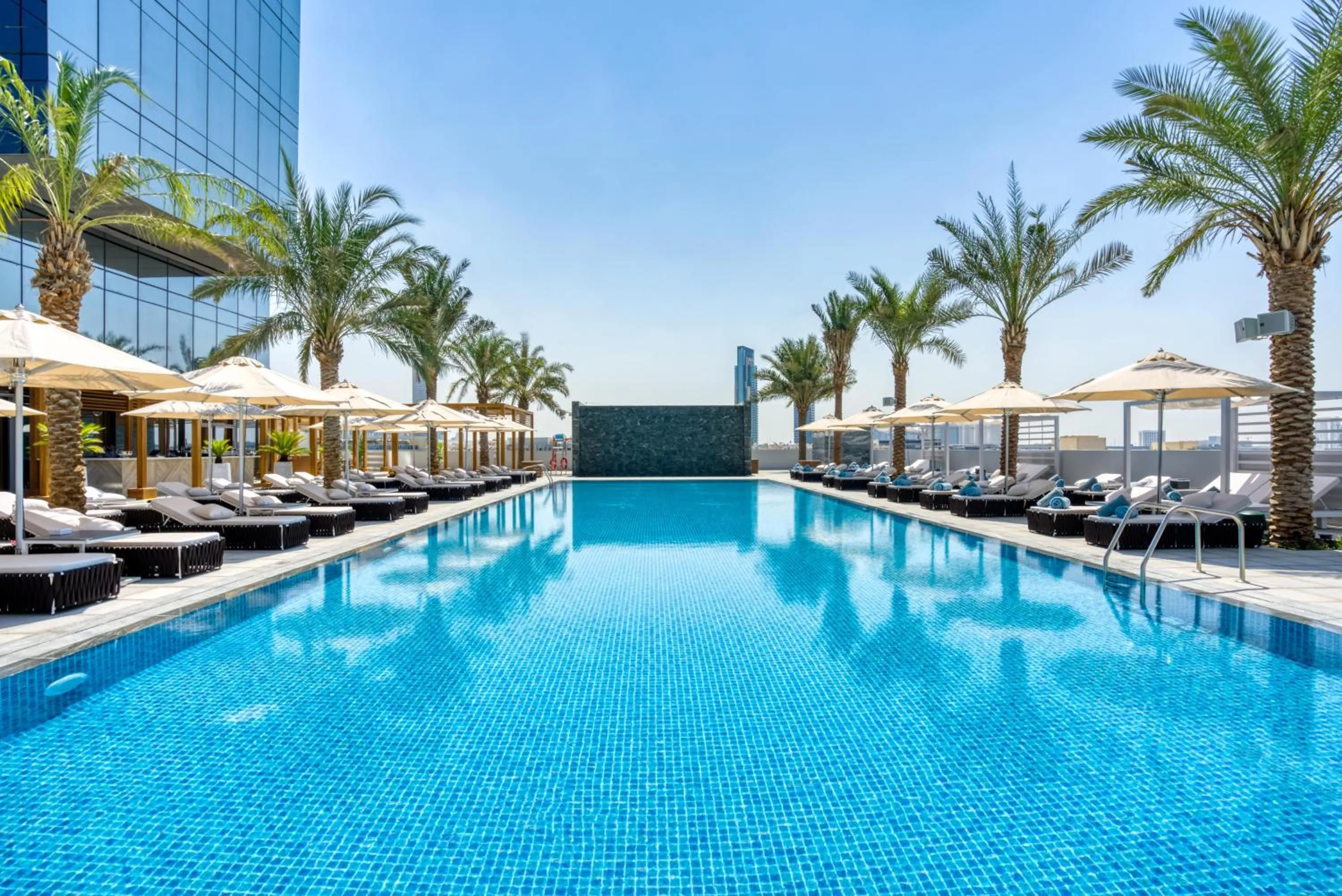 Swimming pool in The First Collection Dubai Jumeirah Village Circle, a Tribute Portfolio Hotel