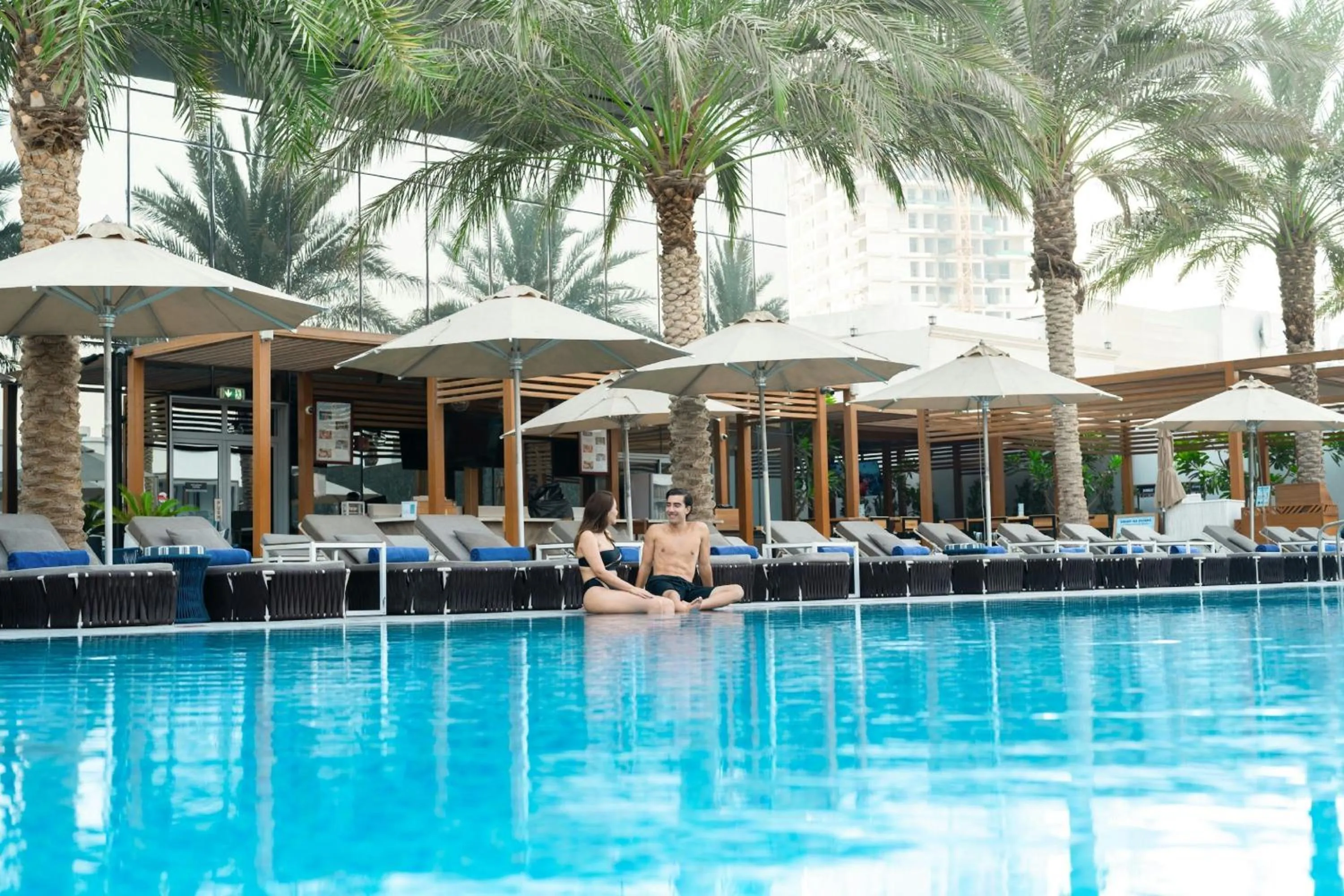 Swimming pool in The First Collection Dubai Jumeirah Village Circle, a Tribute Portfolio Hotel