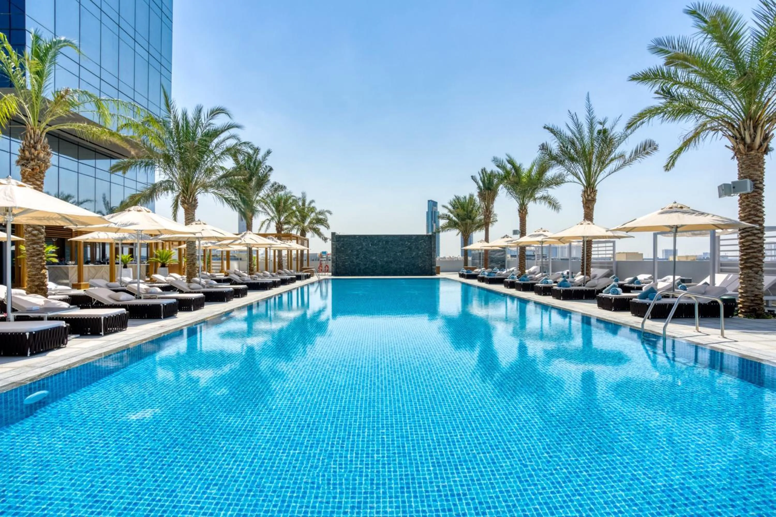 Swimming pool in The First Collection Dubai Jumeirah Village Circle, a Tribute Portfolio Hotel