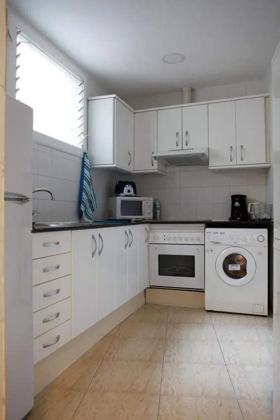 Kitchen or kitchenette in Colom Apartments