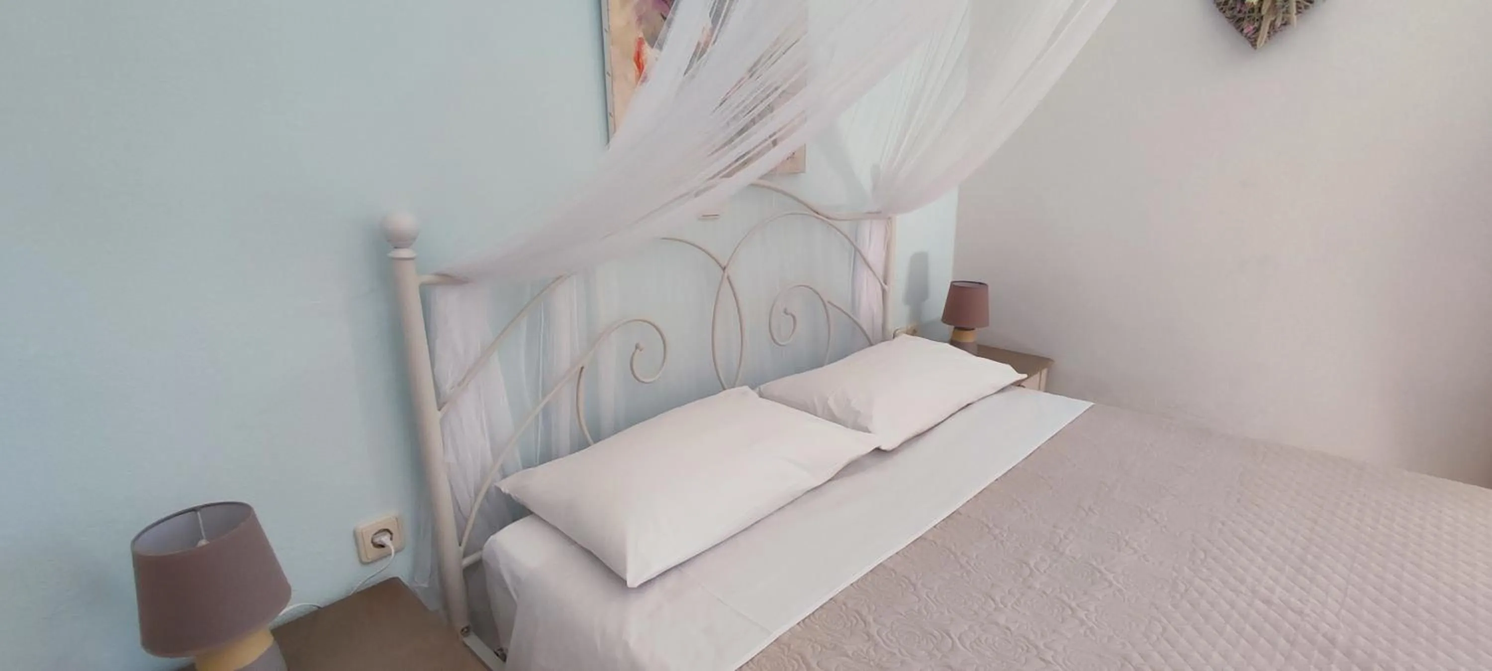 Bed in Niki Apartments