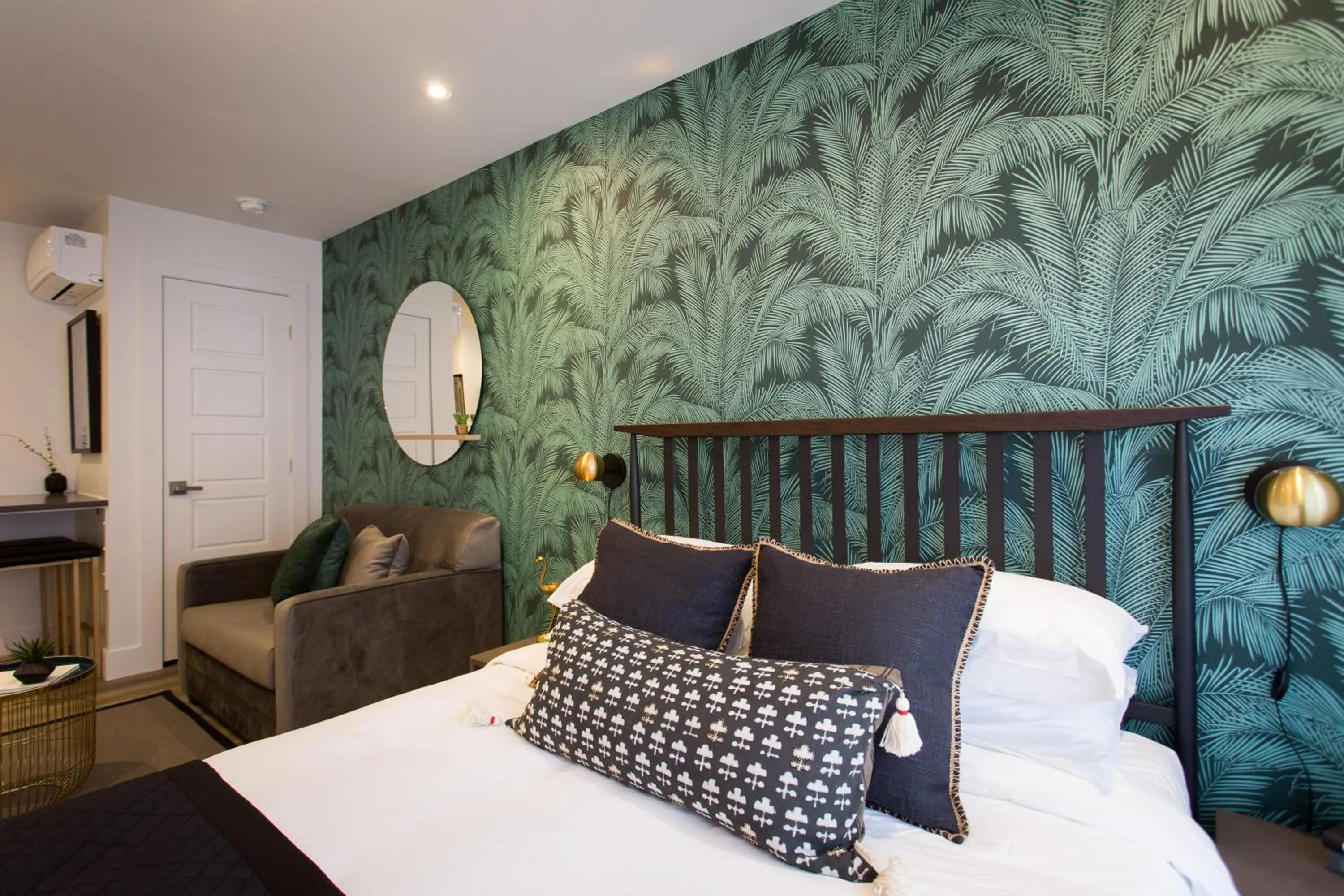 Bed in Blue Tropics Studio in Little Italy with kitchen by Den Stays