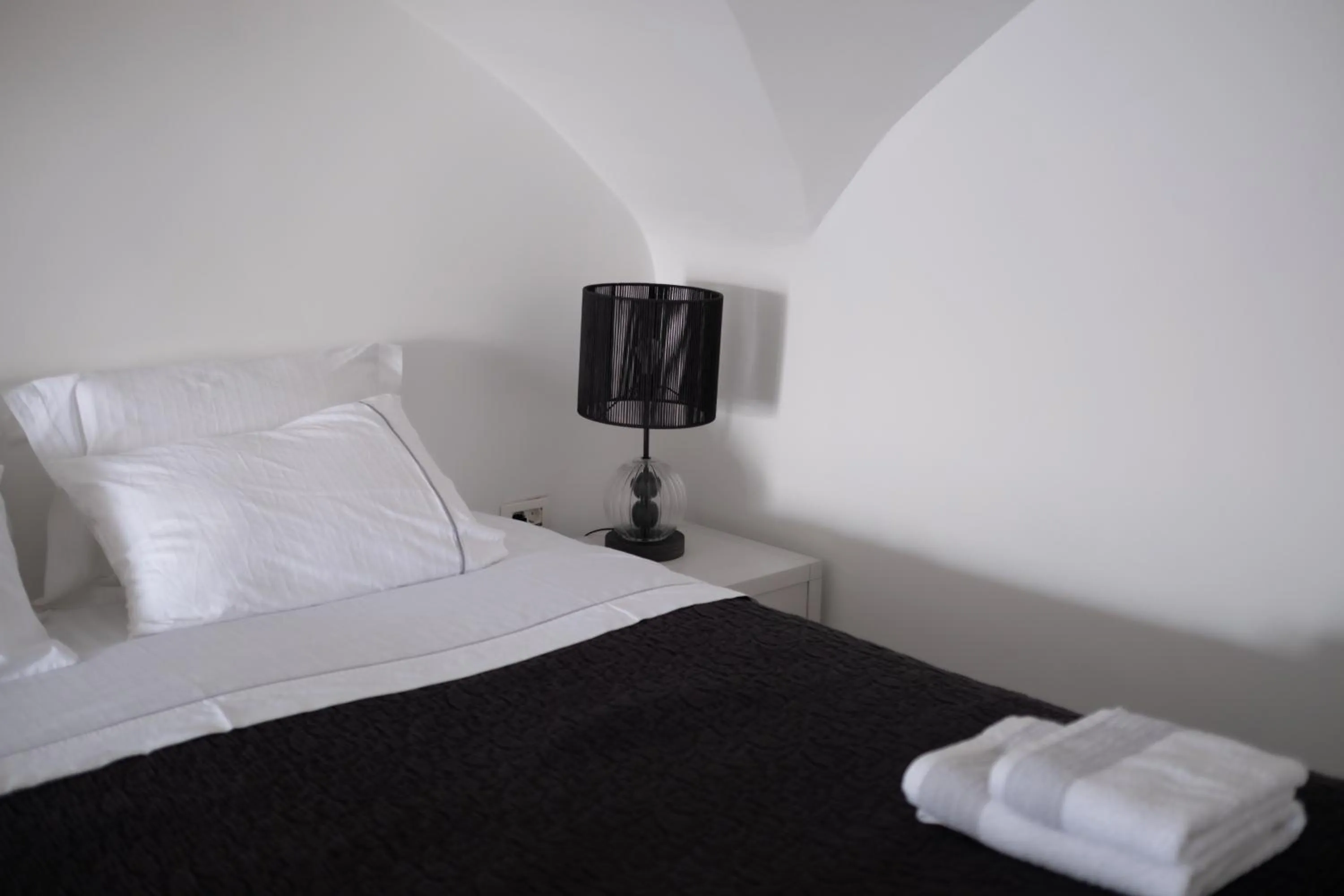 Bed in Anemos Cave Suites