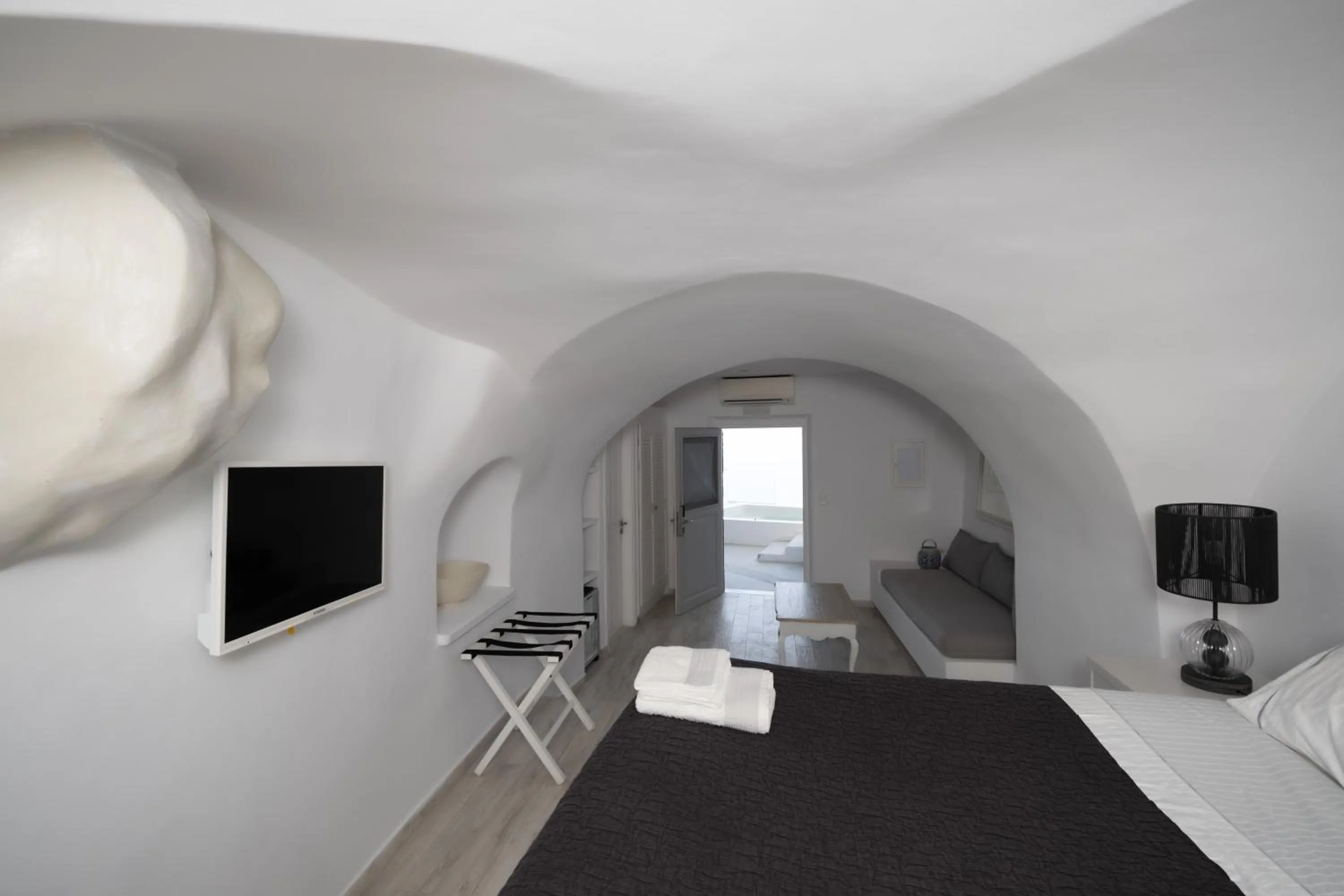 Bed in Anemos Cave Suites