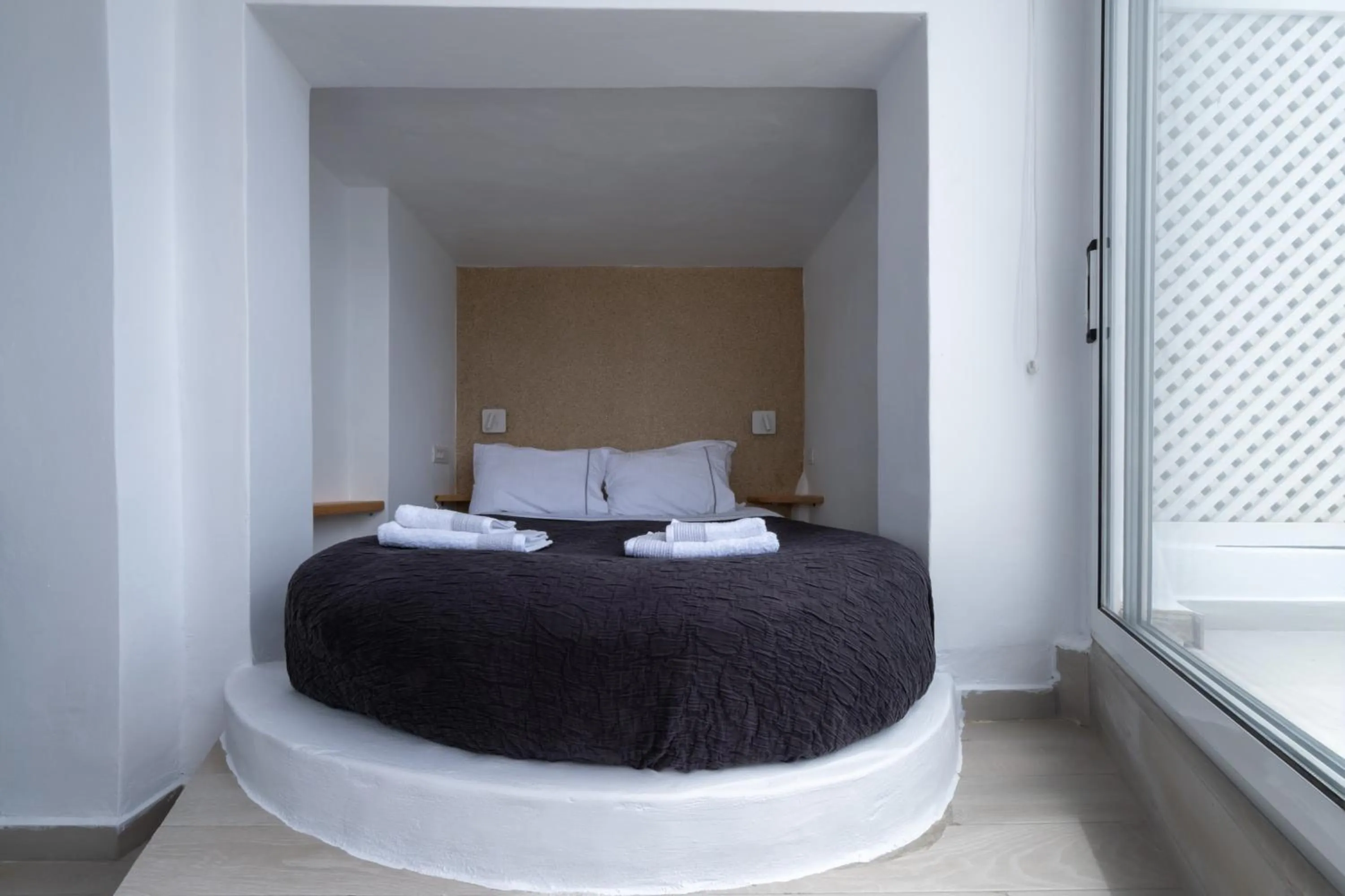 Bed in Anemos Cave Suites