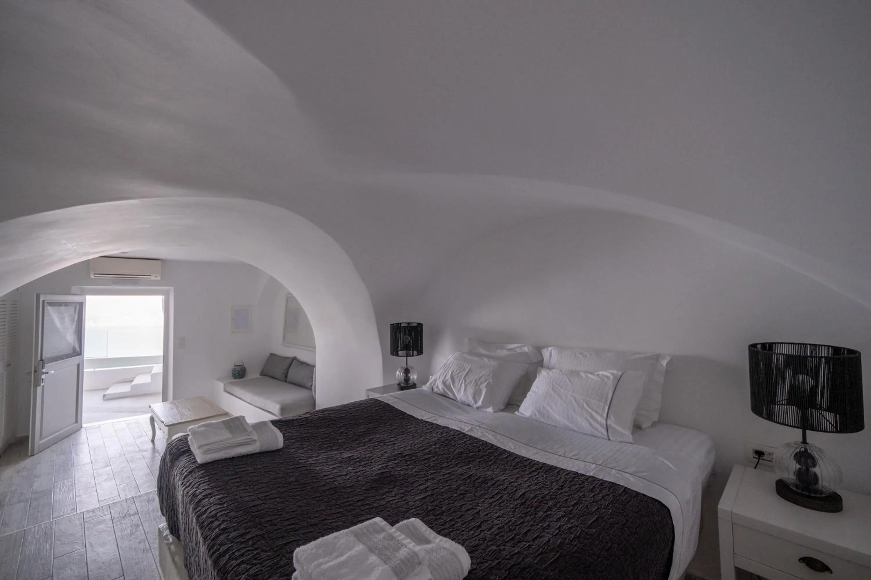 Bed in Anemos Cave Suites