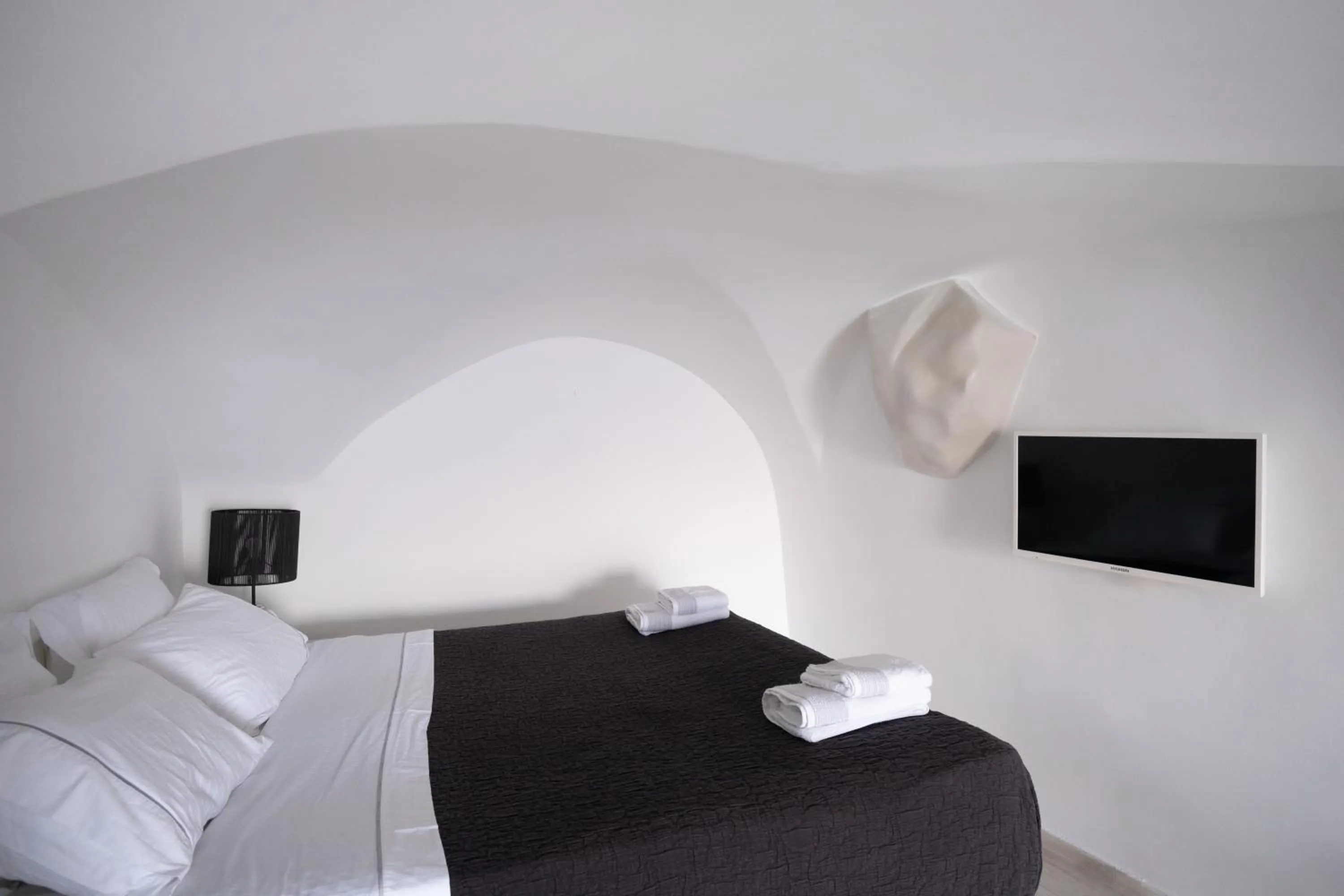 Bed in Anemos Cave Suites